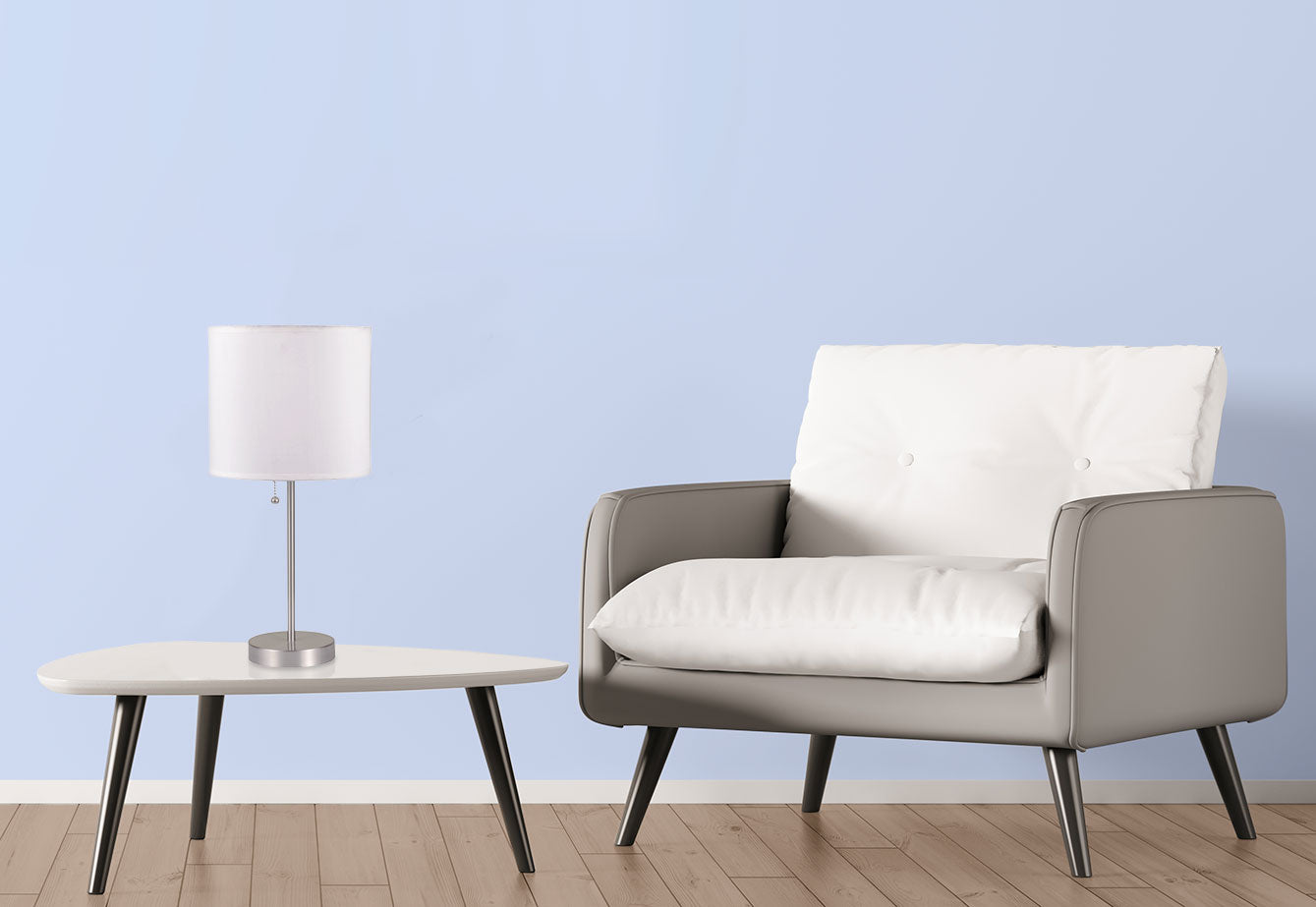Contemporary silver desk lamp with white fabric shade on a modern white table