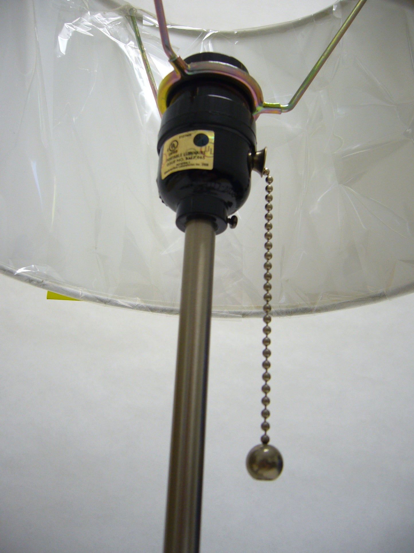Chrome pull chain extends from black lamp socket used for easy light control