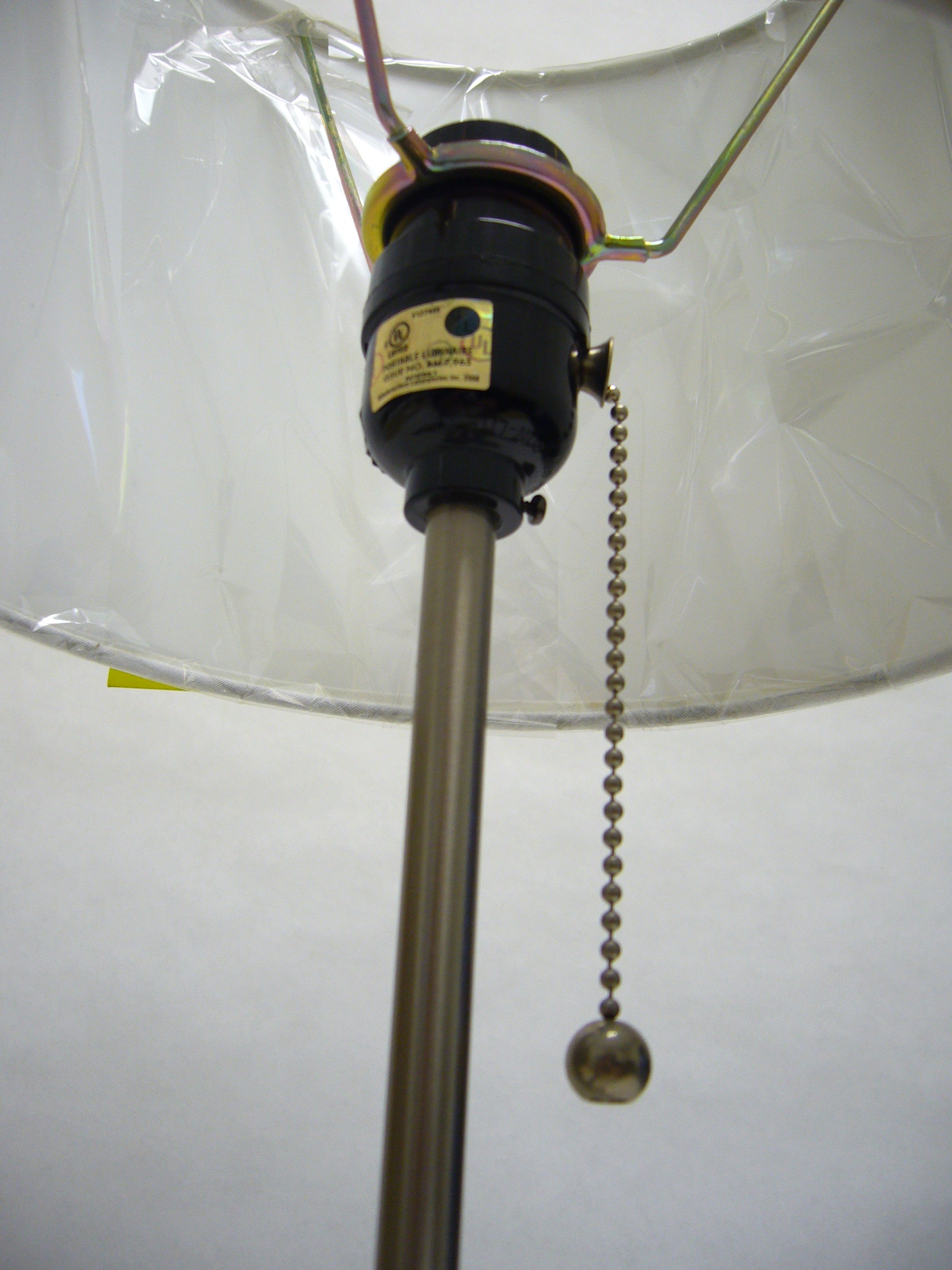 Chrome pull chain extends from black lamp socket used for easy light control