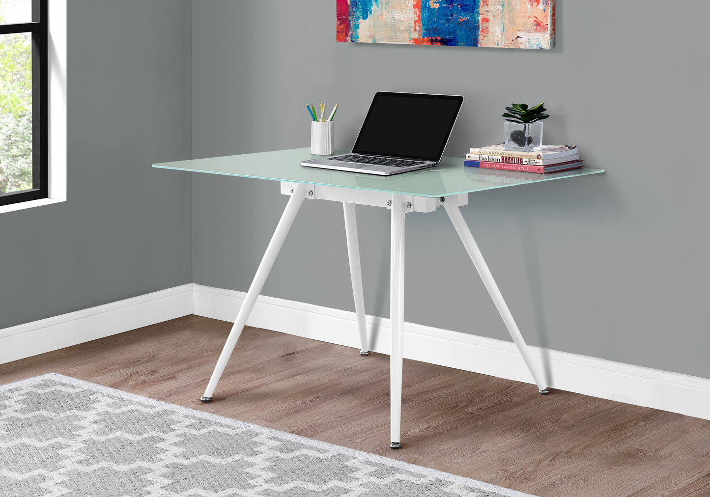 Modern glass desk with white tripod legs perfect for a home office setup