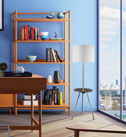 Modern floor lamp with white drum shade and dark wood accent table