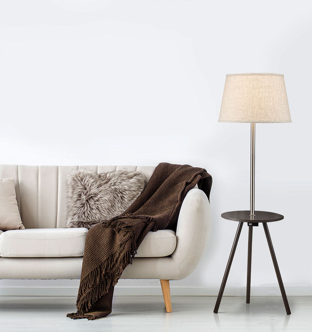 Elegant floor lamp with a textured cream shade and a builtin side table for modern living rooms