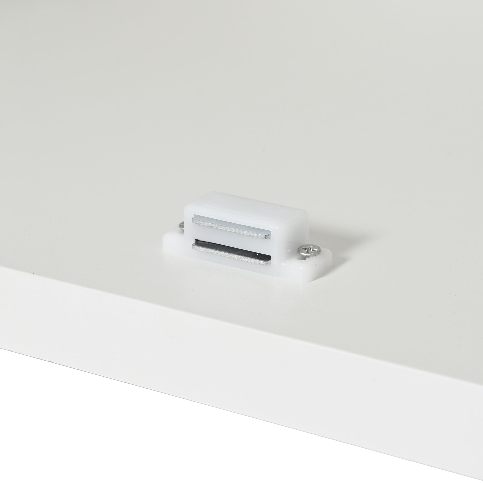 White plastic magnetic catch with silver metal strips ideal for cabinet doors