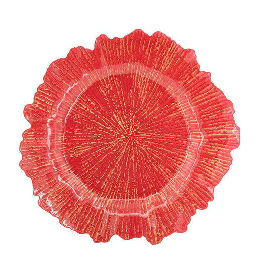 Red glass charger plate with fluted rim and sunburst texture
