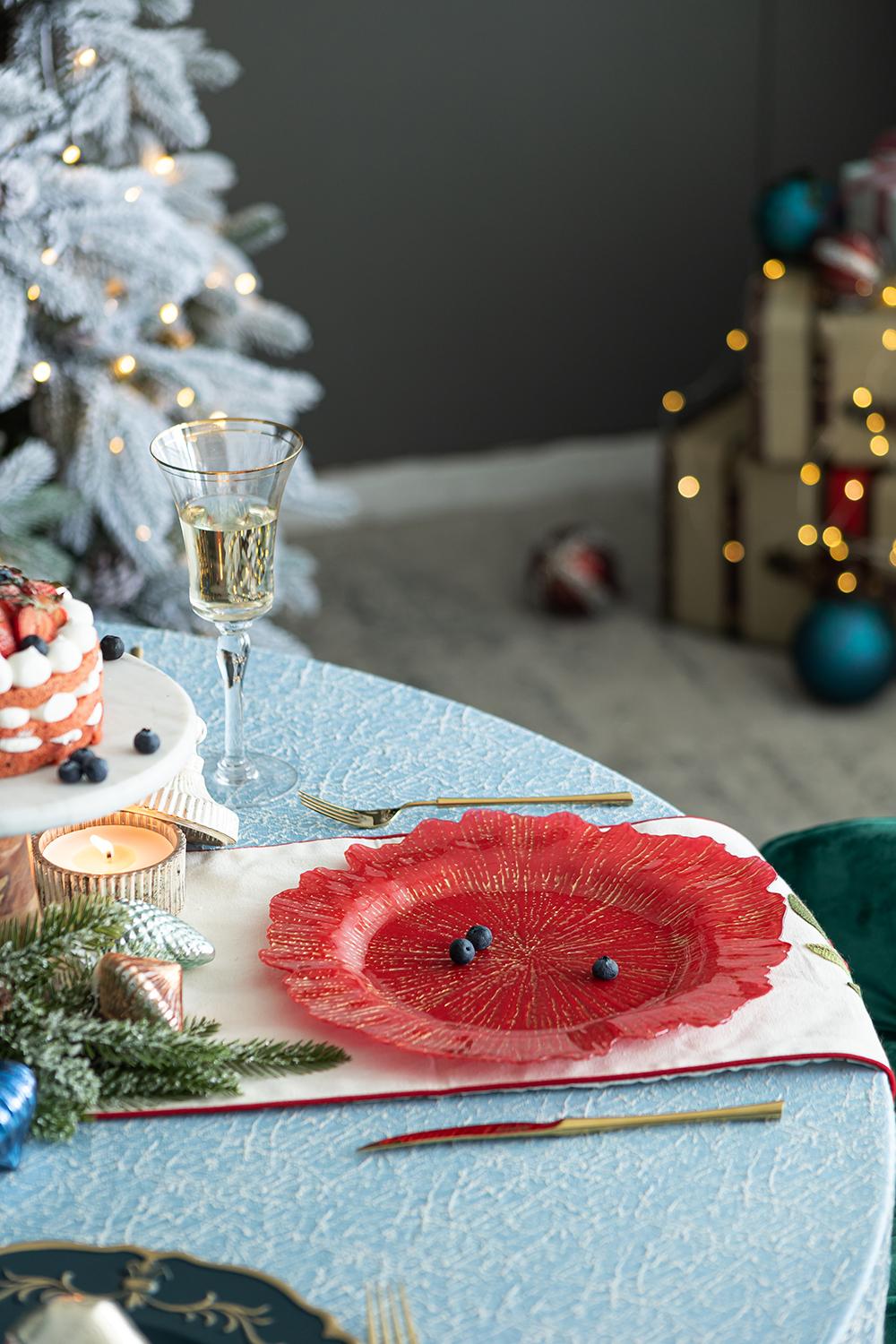Elegant red glass charger plate with gold sunburst design and ruffled edge perfect for holiday dinners