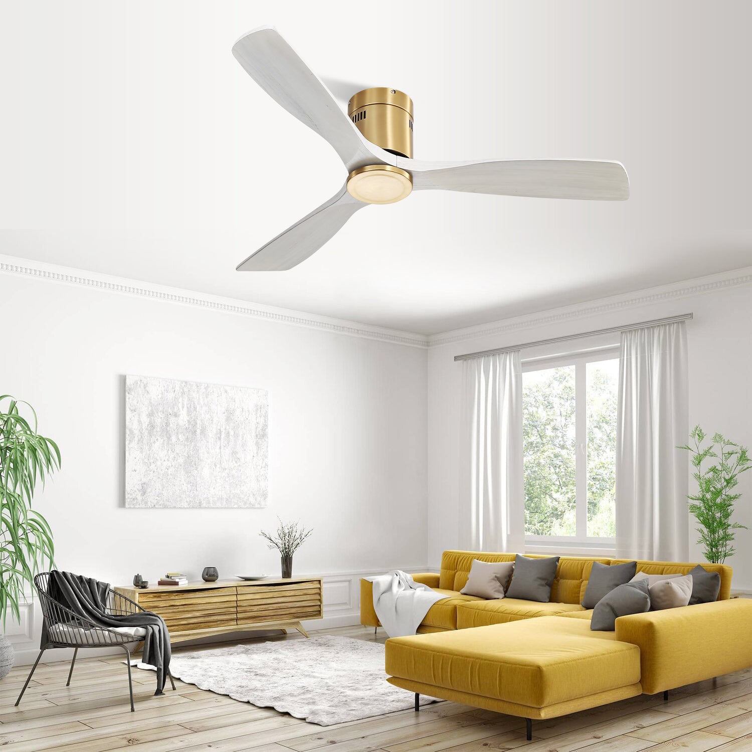 Modern ceiling fan with white blades and brushed brass accents in a living room