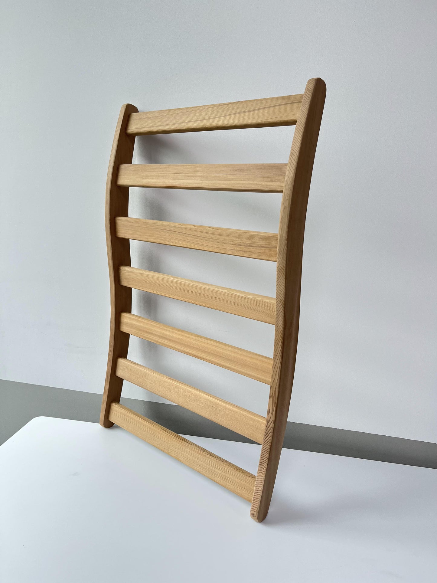 Curved wooden chair back with horizontal slats ideal for modern seating