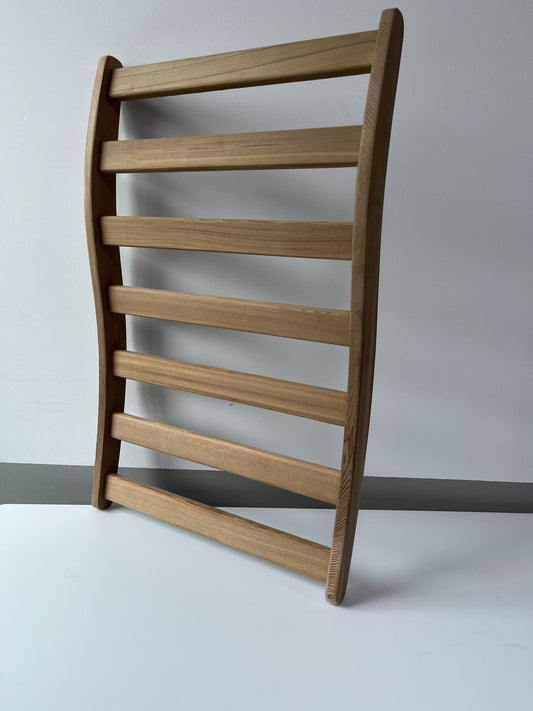 Modern bentwood wall shelf in natural oak finish for displaying decor