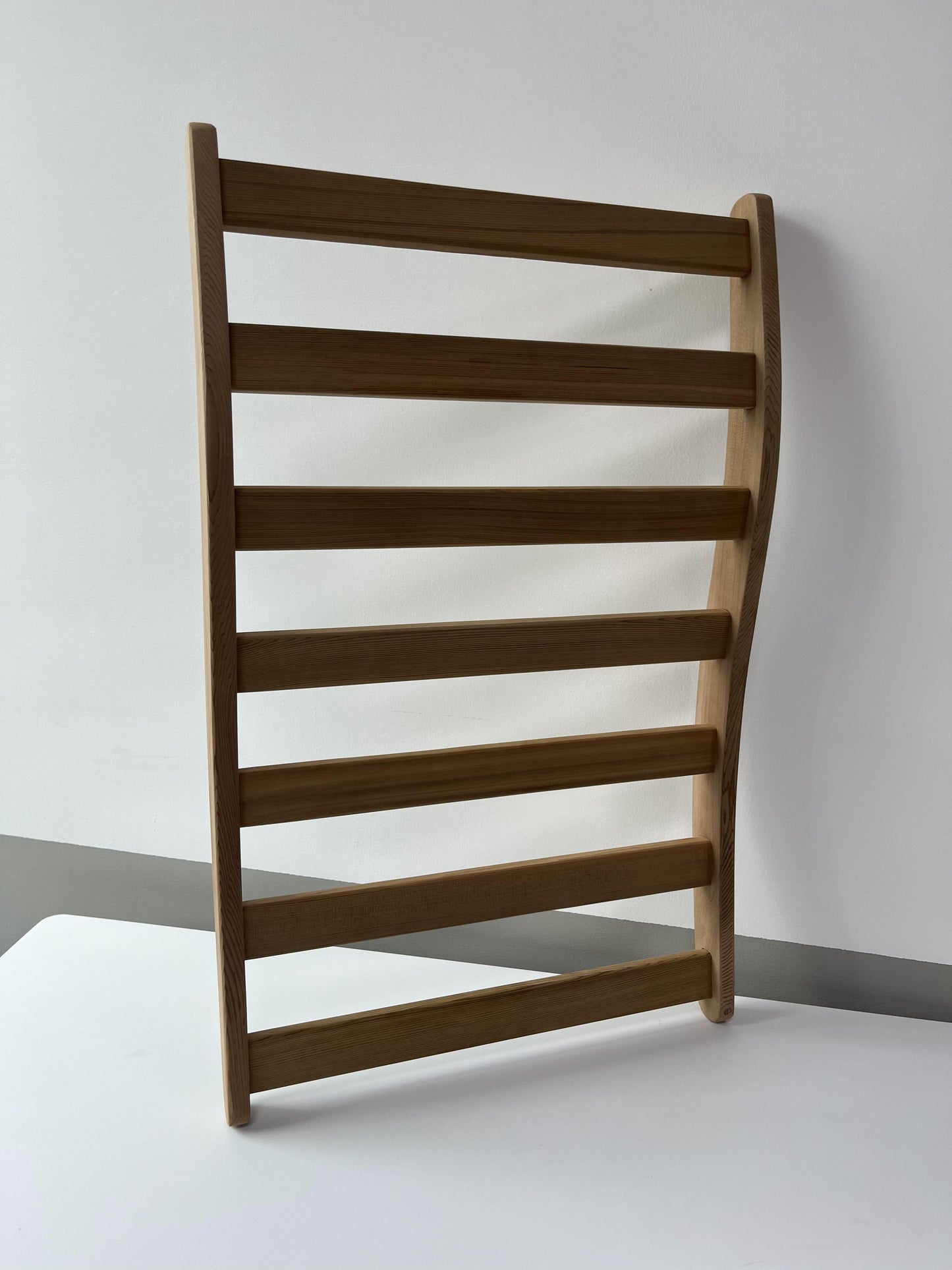 Natural wood ladder rack with horizontal bars for towel storage