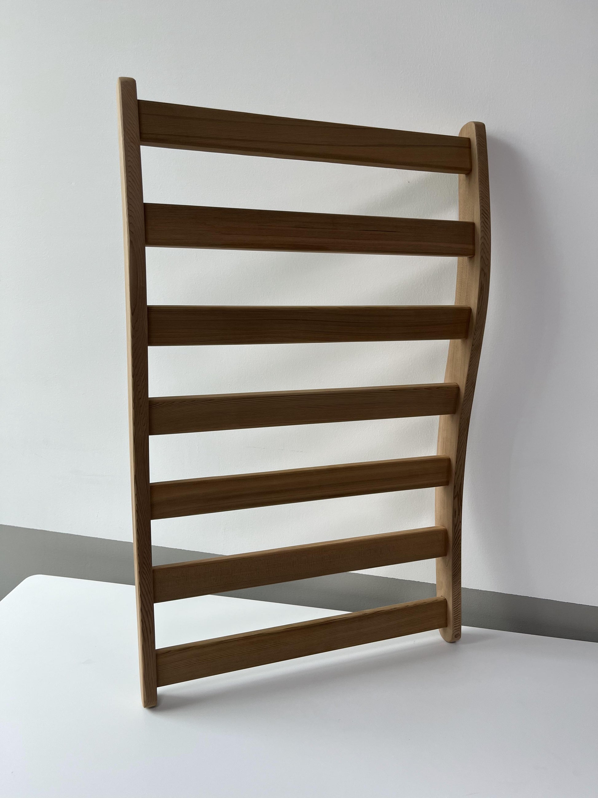 Natural wood ladder rack with horizontal bars for towel storage