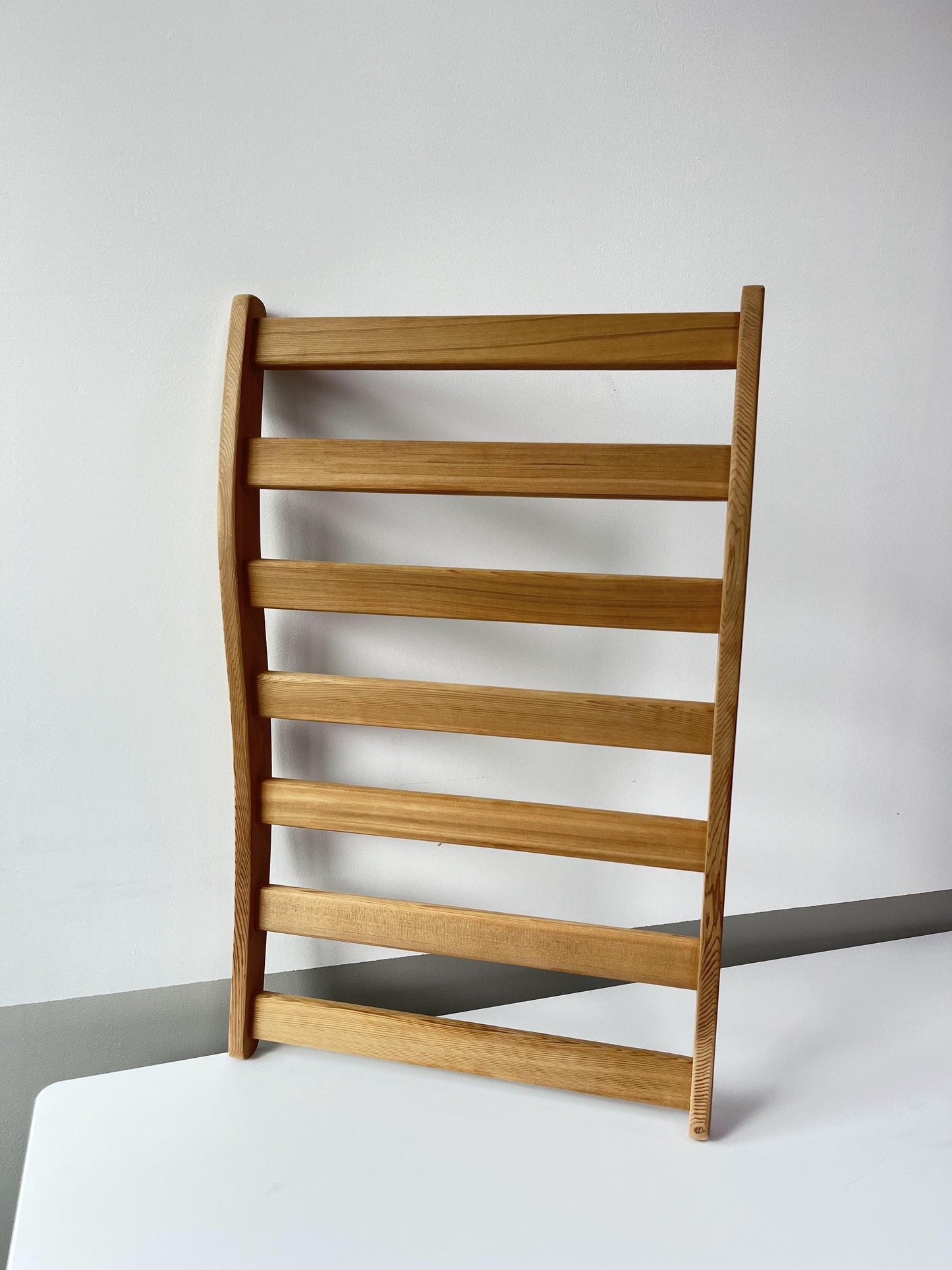 Minimalist light wood chair with slatted back ideal for modern dining spaces