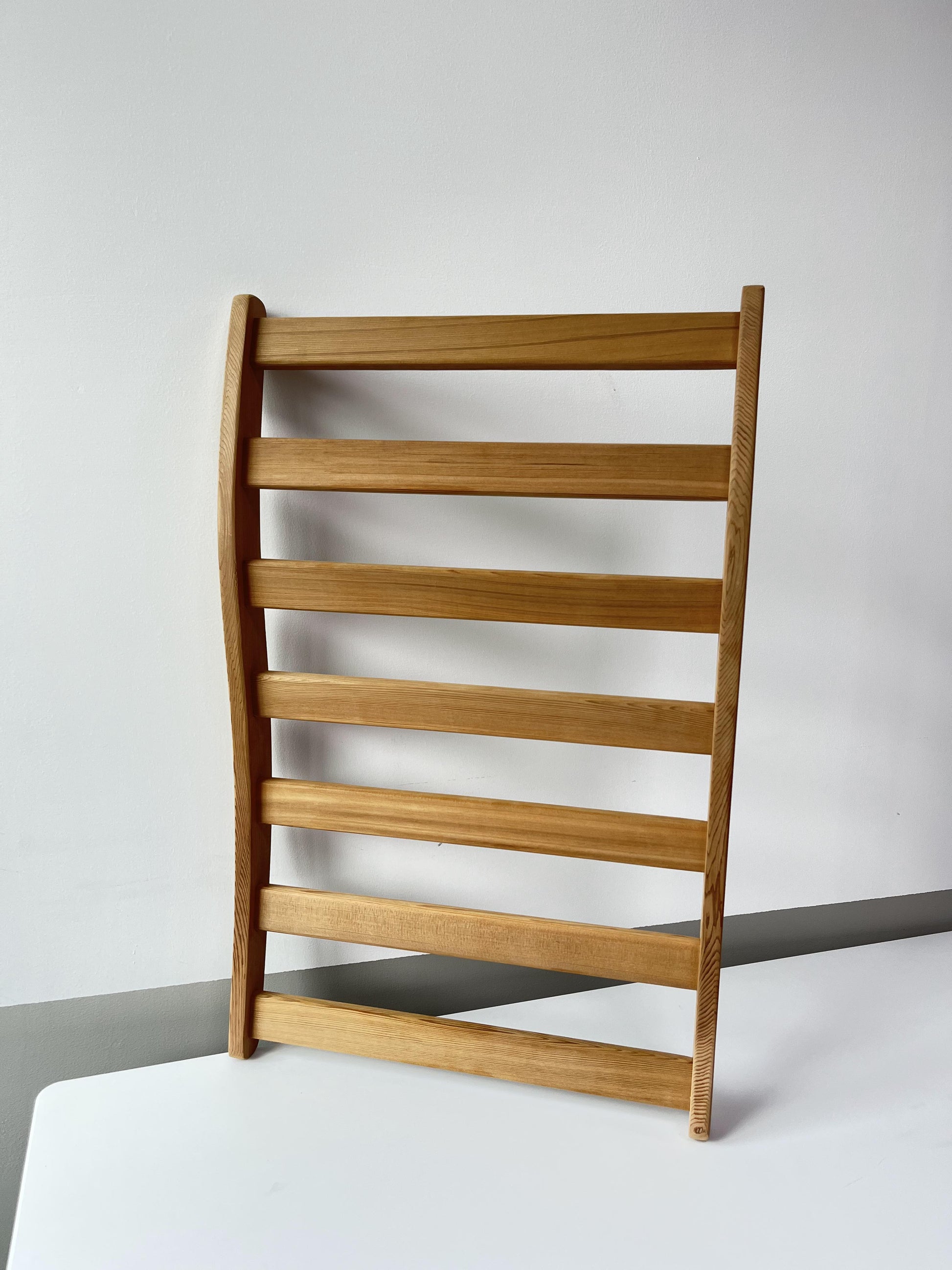 Minimalist light wood chair with slatted back ideal for modern dining spaces