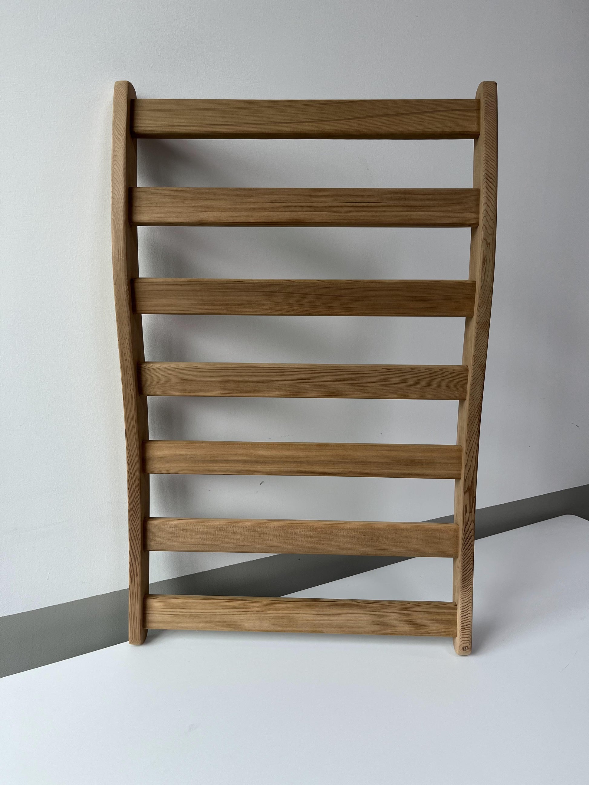 Minimalist natural wood towel rack with sleek horizontal slats