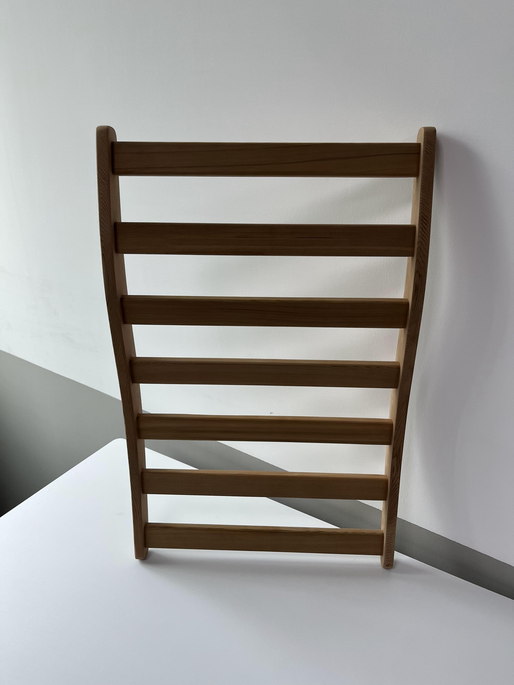 Natural wood ladder shelf with sleek modern design for home organization