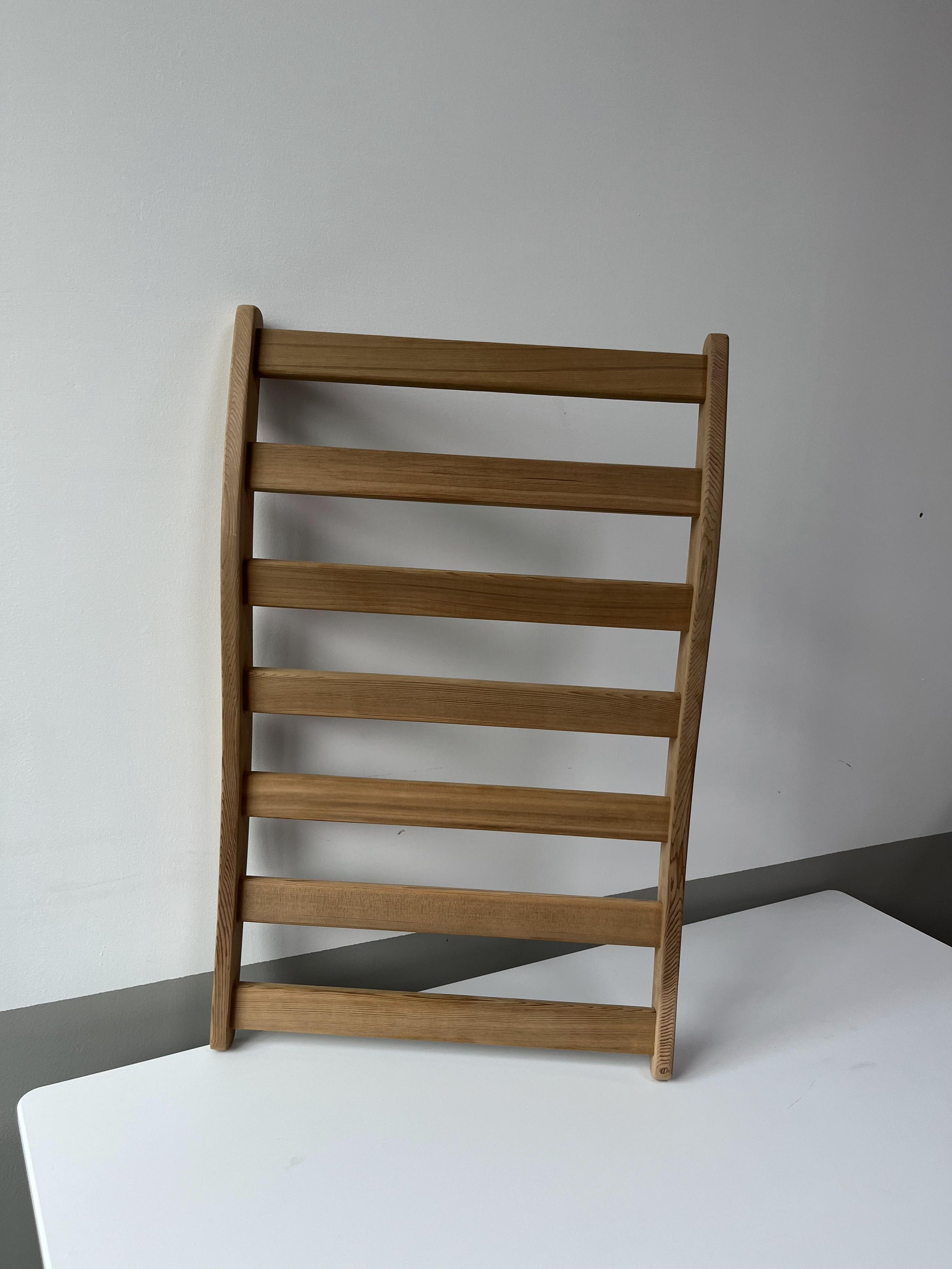 Natural wood ladder shelf with horizontal slats for modern storage solutions