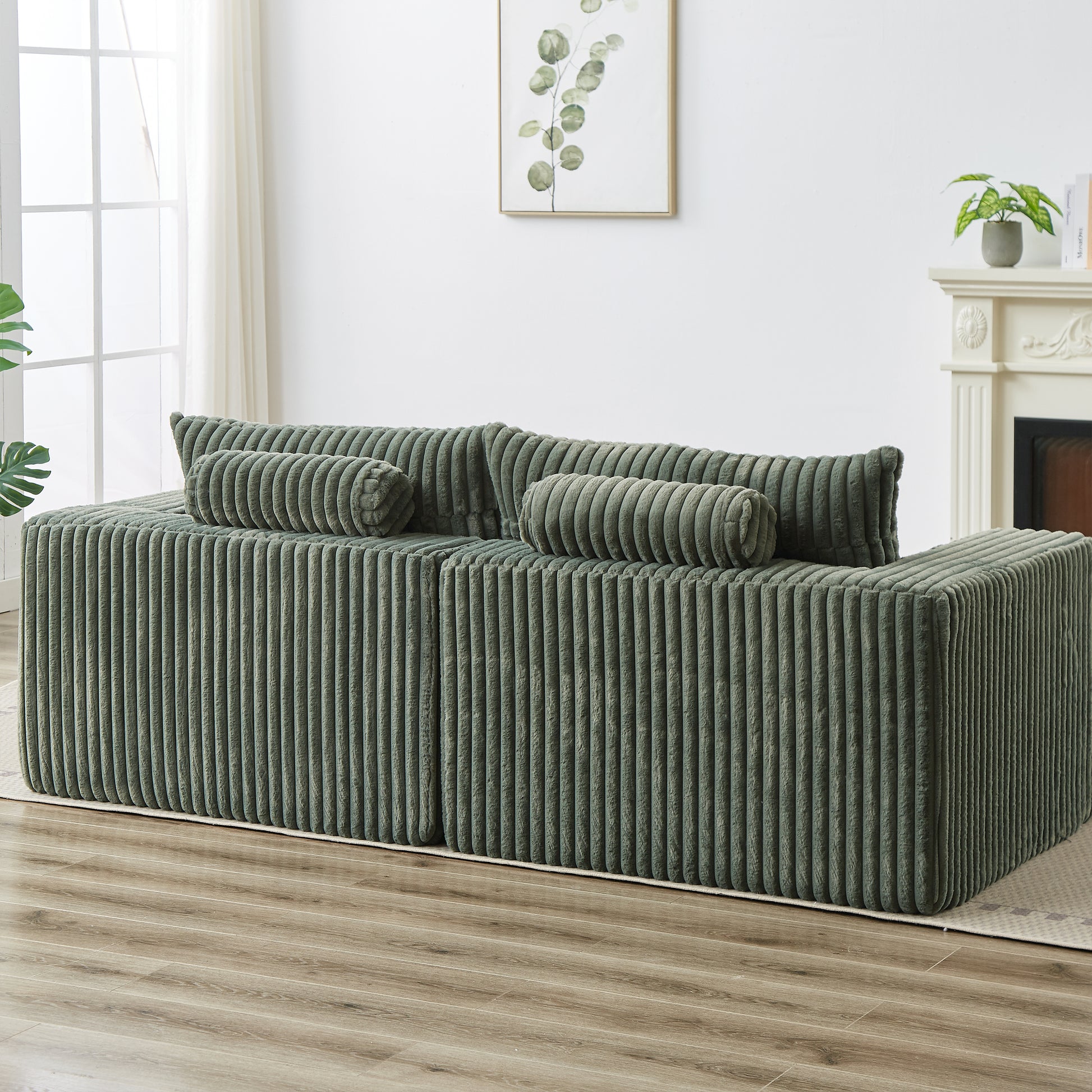 Sage green corduroy modular sofa with plush bolster pillows for modern living room comfort