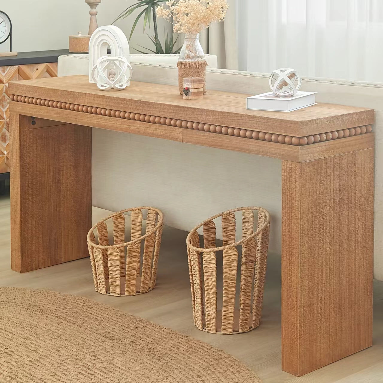 Wooden console table with beaded trim and two wicker baskets below