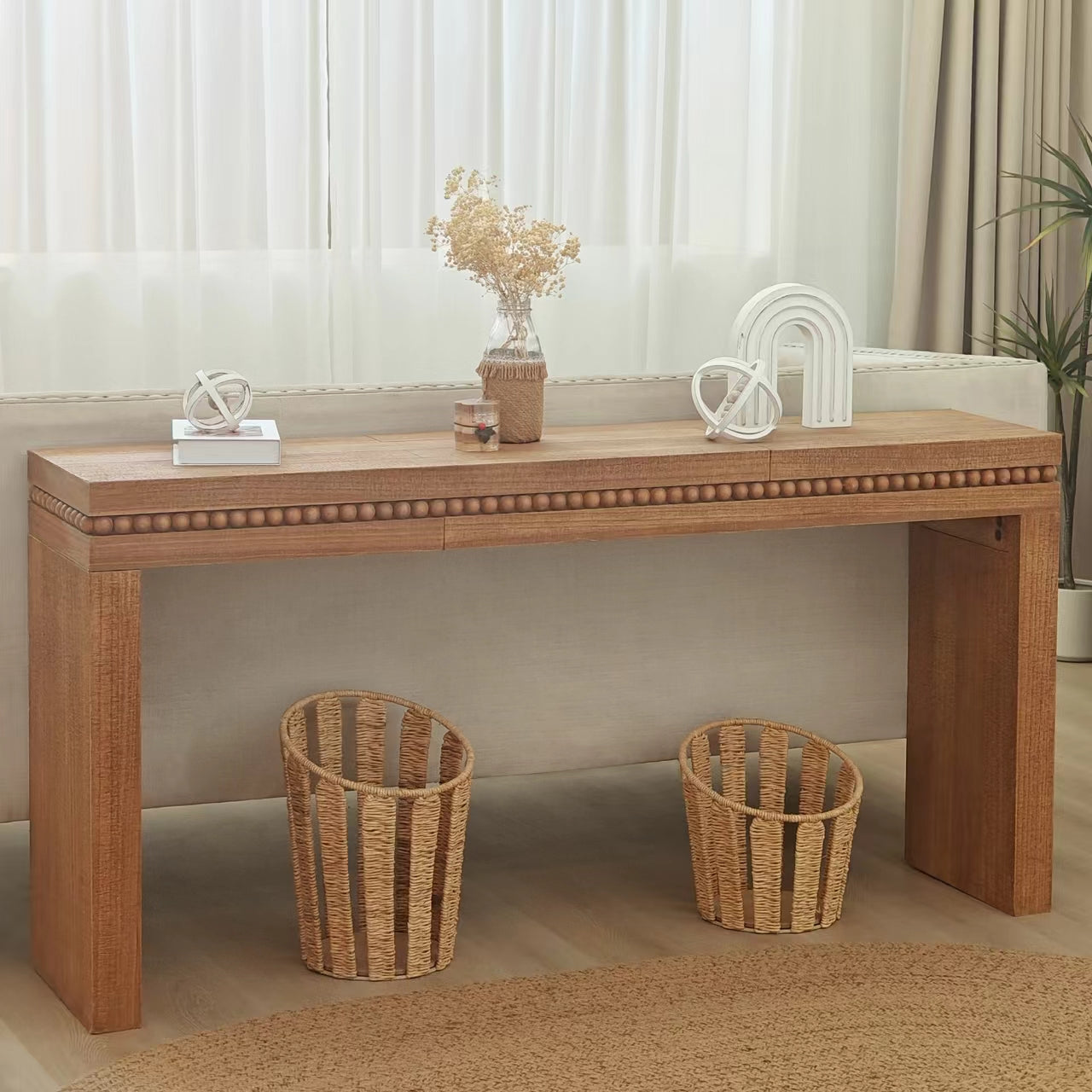 Wooden console table with decorative beaded trim and drawers ideal for entryways