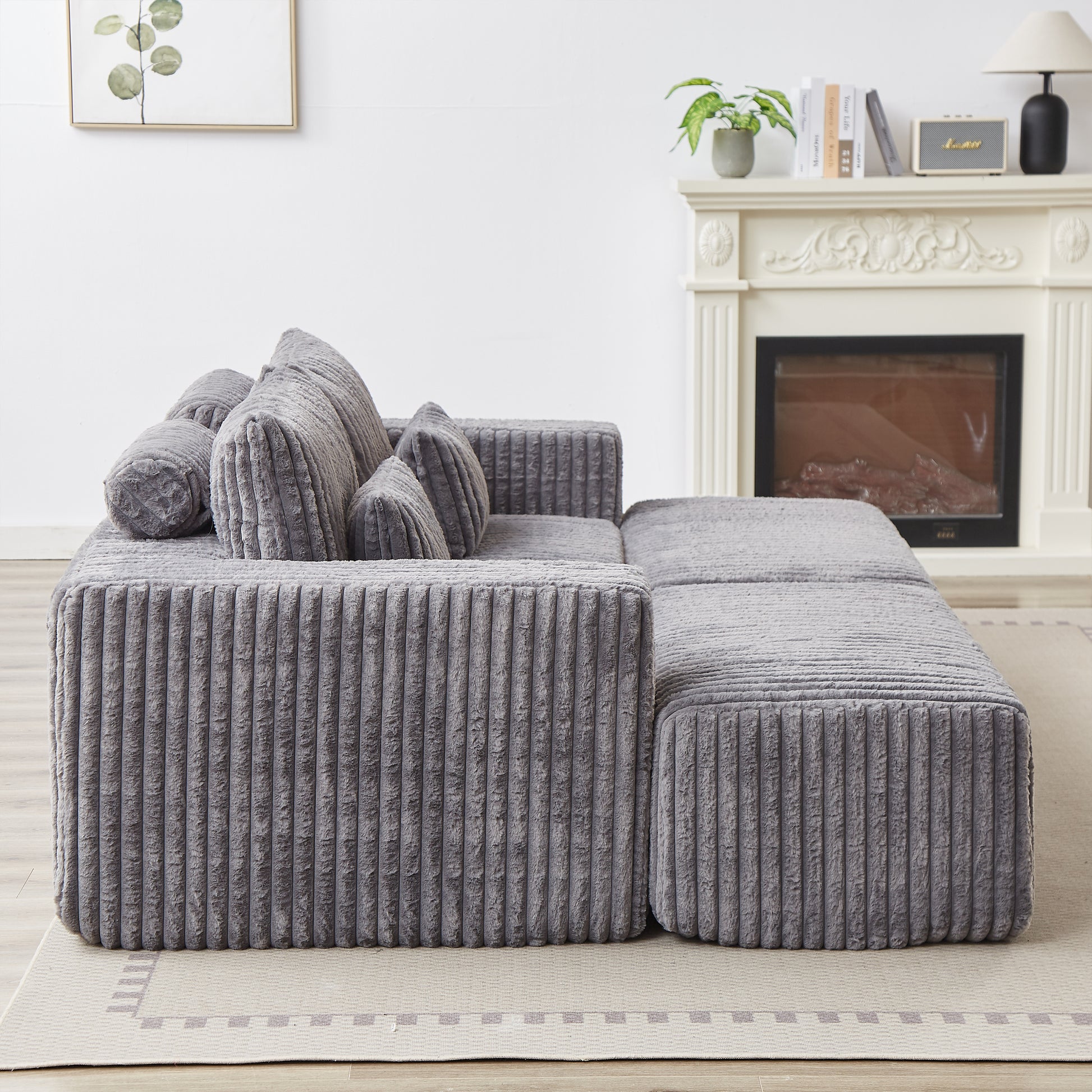 Plush corduroy sectional sofa in charcoal grey with matching lumbar pillows for a cozy living room
