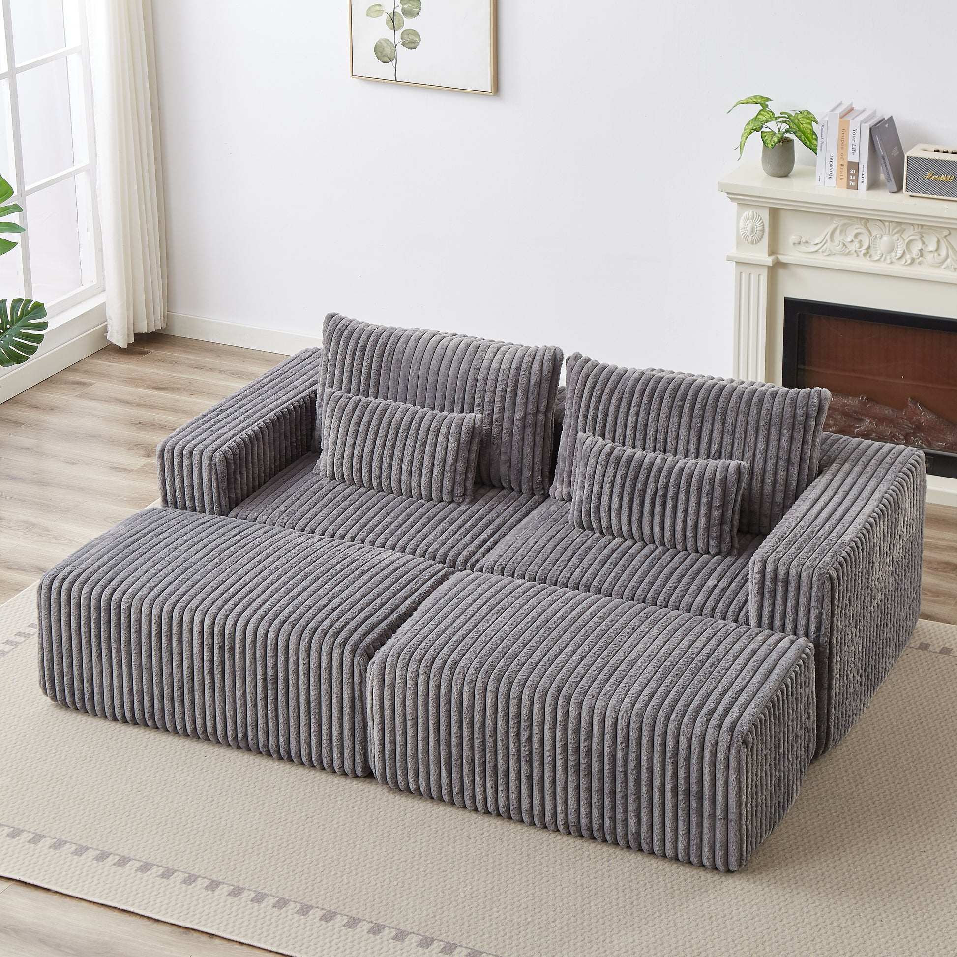 Plush grey corduroy sectional sofa with plush throw pillows perfect for a cozy living room setup