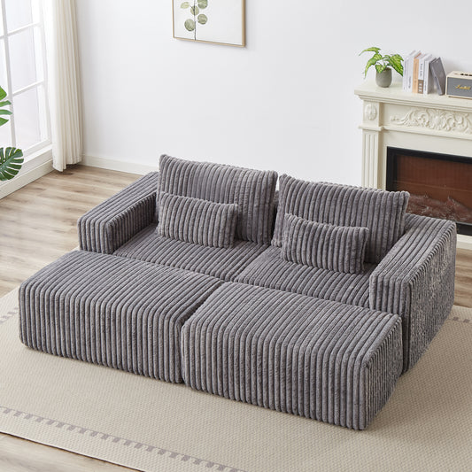 Plush grey corduroy sectional sofa with plush throw pillows perfect for a cozy living room setup