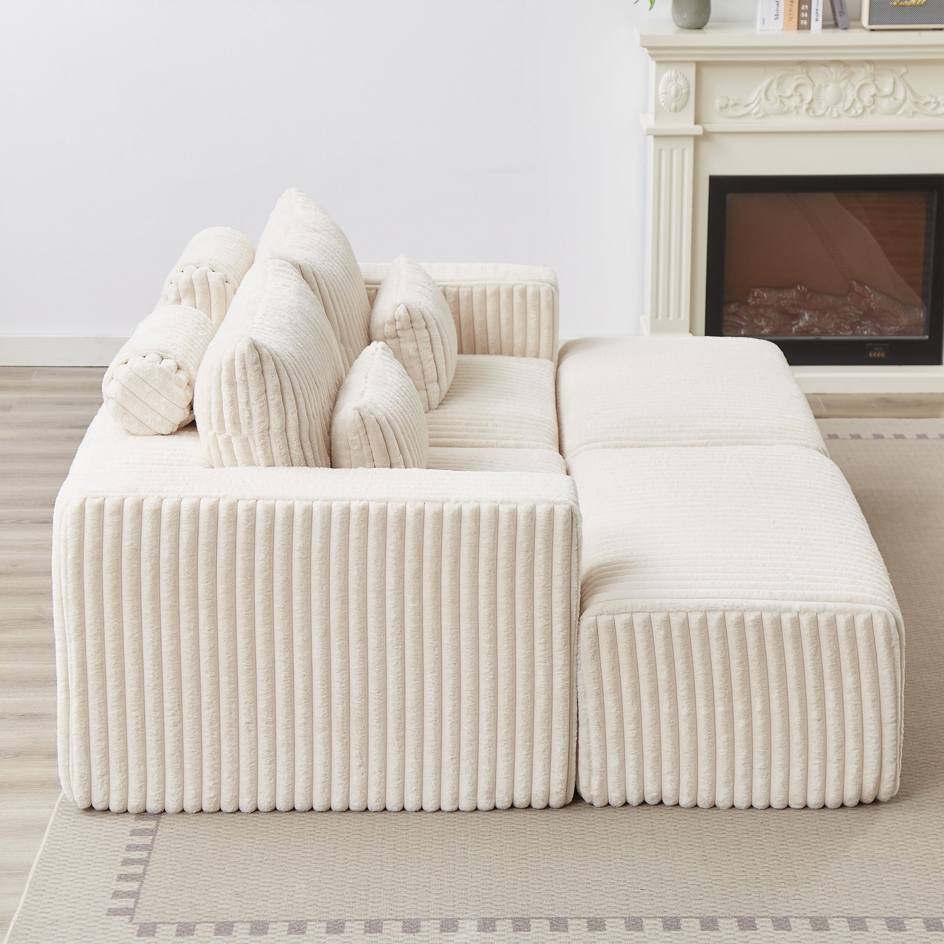Plush cream corduroy sectional sofa with multiple back cushions and bolster pillows
