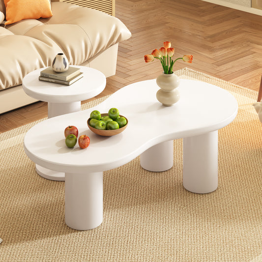 Modern white organic shape coffee table with cylindrical legs holding apples