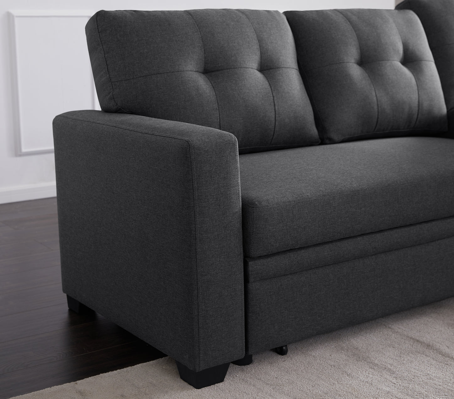 Dark charcoal grey linen sectional sofa with tufted back cushions and armrest