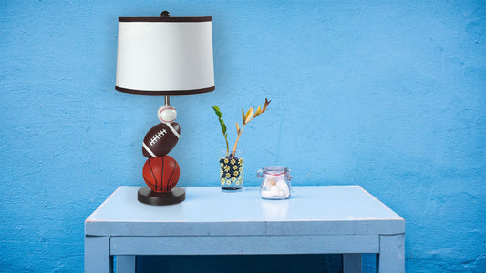 Sportsthemed table lamp with basketball football and baseball elements for a childs room