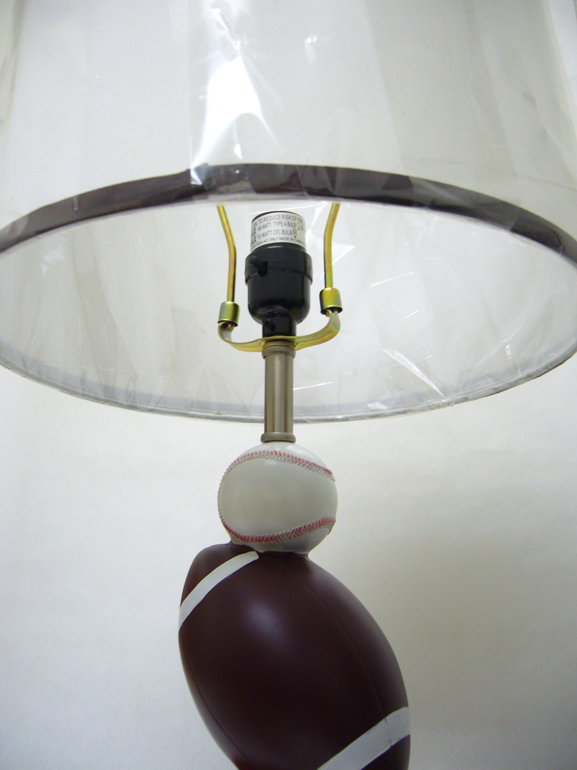 Sportsthemed desk lamp with a brown football base and white baseball stack