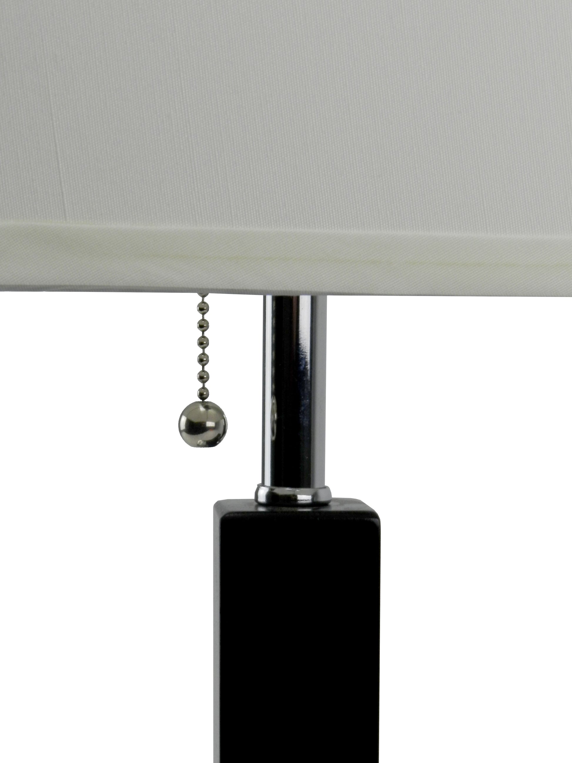 Close up of a modern black table lamp base with chrome pole and pull chain