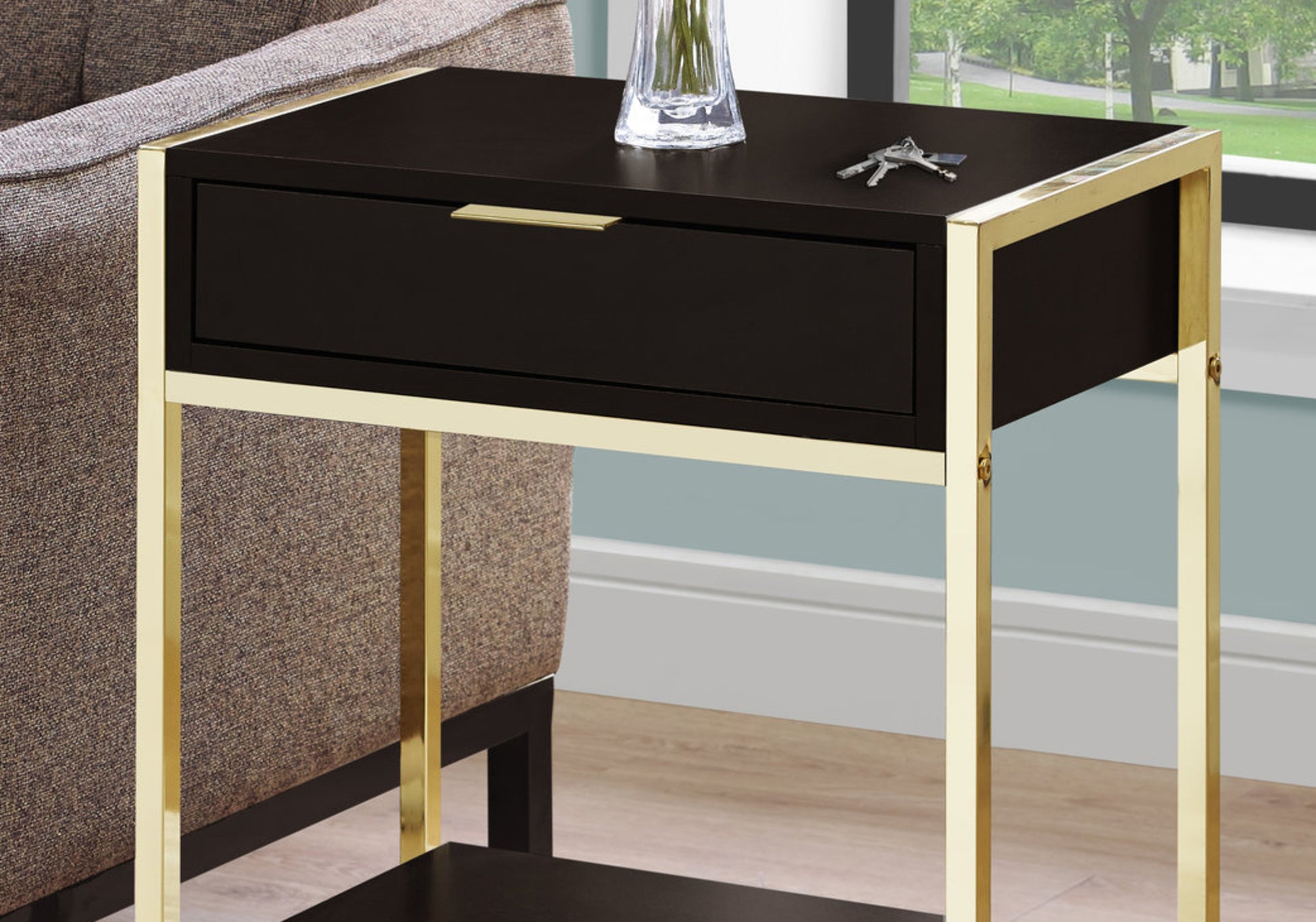 Modern black end table with polished gold frame and single drawer