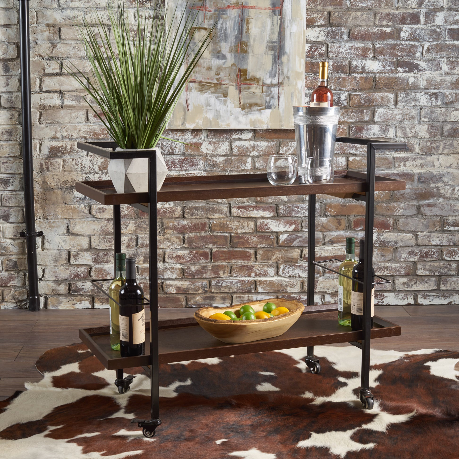 Twotier dark wood bar cart with wine bottles and fruit