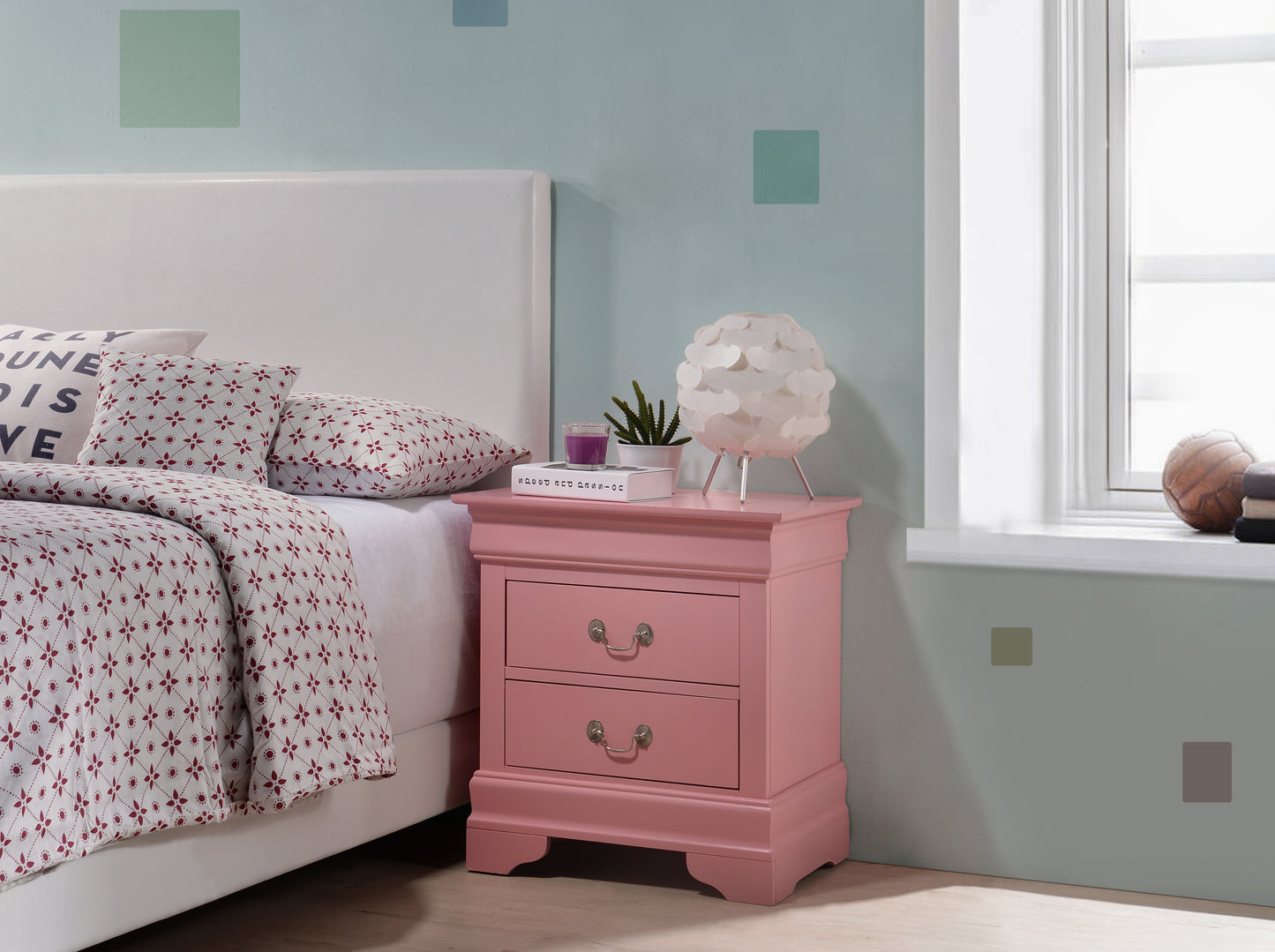 Pink bedside table with two drawers and ornate handles perfect for bedroom storage