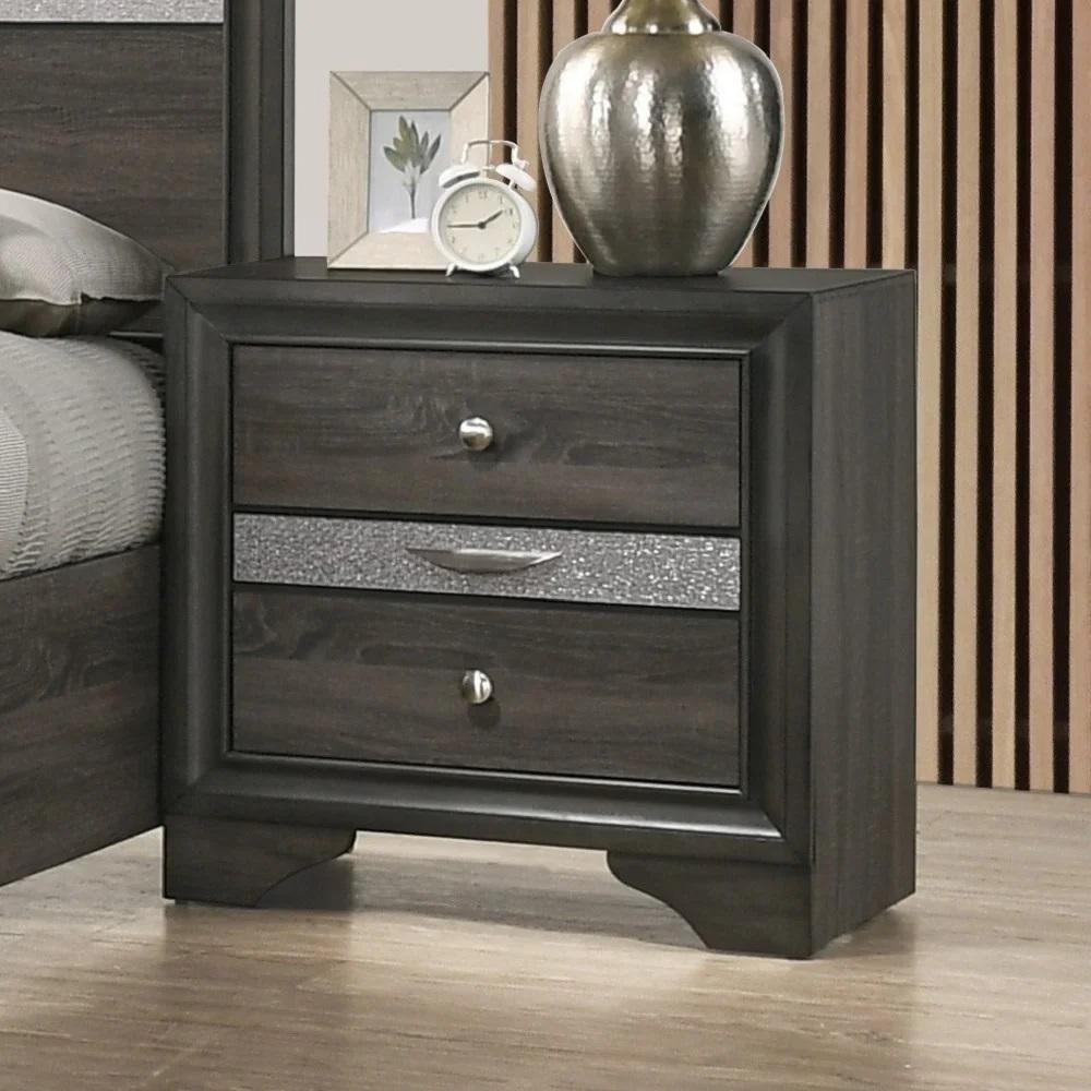 Dark gray wood nightstand with three drawers and decorative silver accents