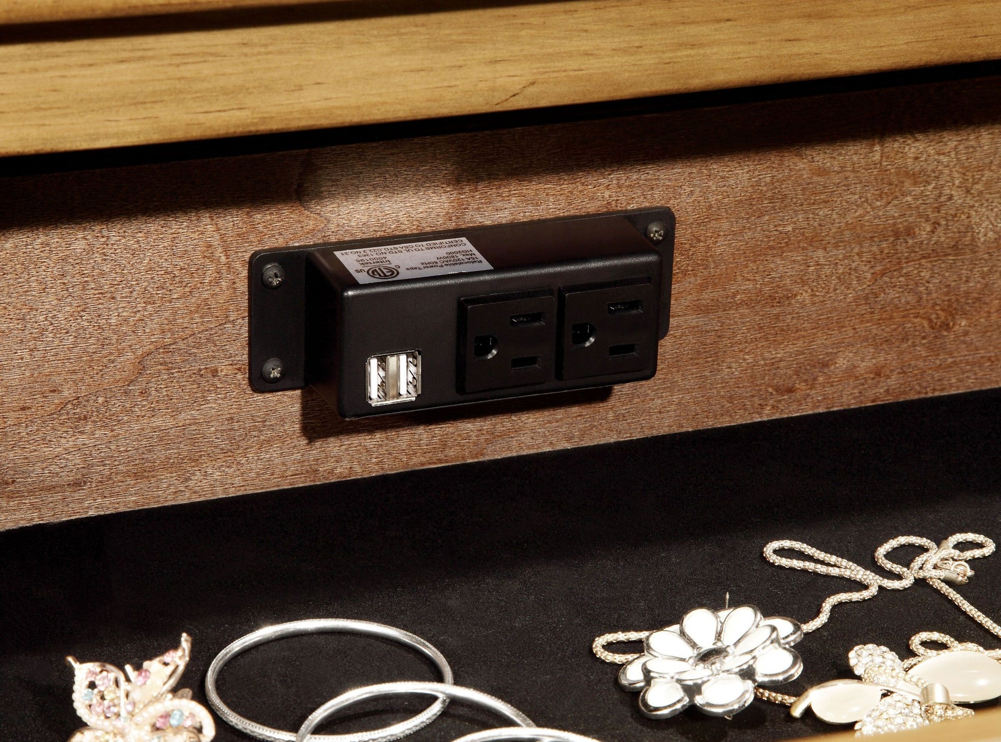Black power tap with  USB ports and  outlets on wood grain surface