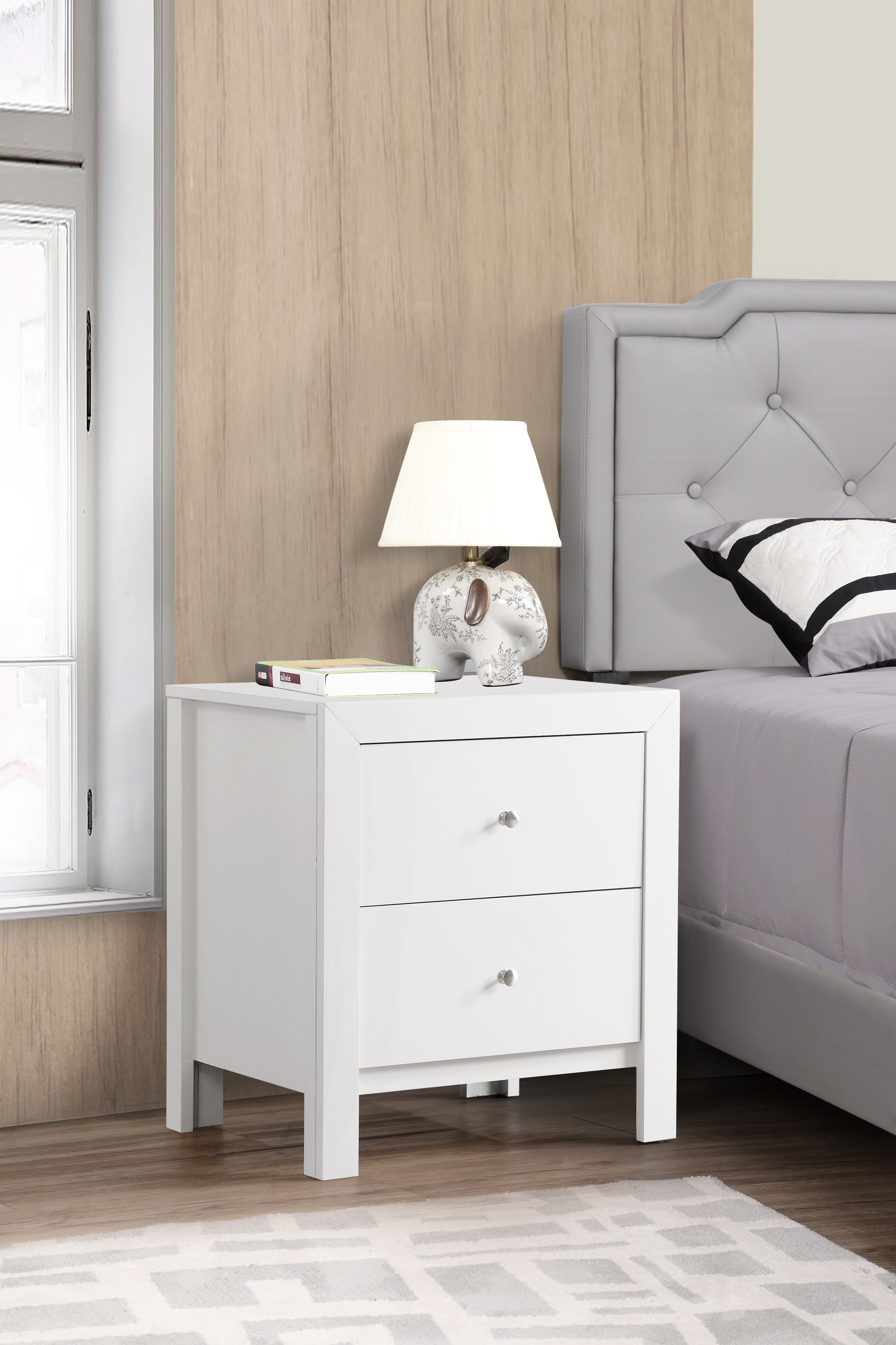 White twodrawer nightstand with silver knobs ideal for bedroom storage
