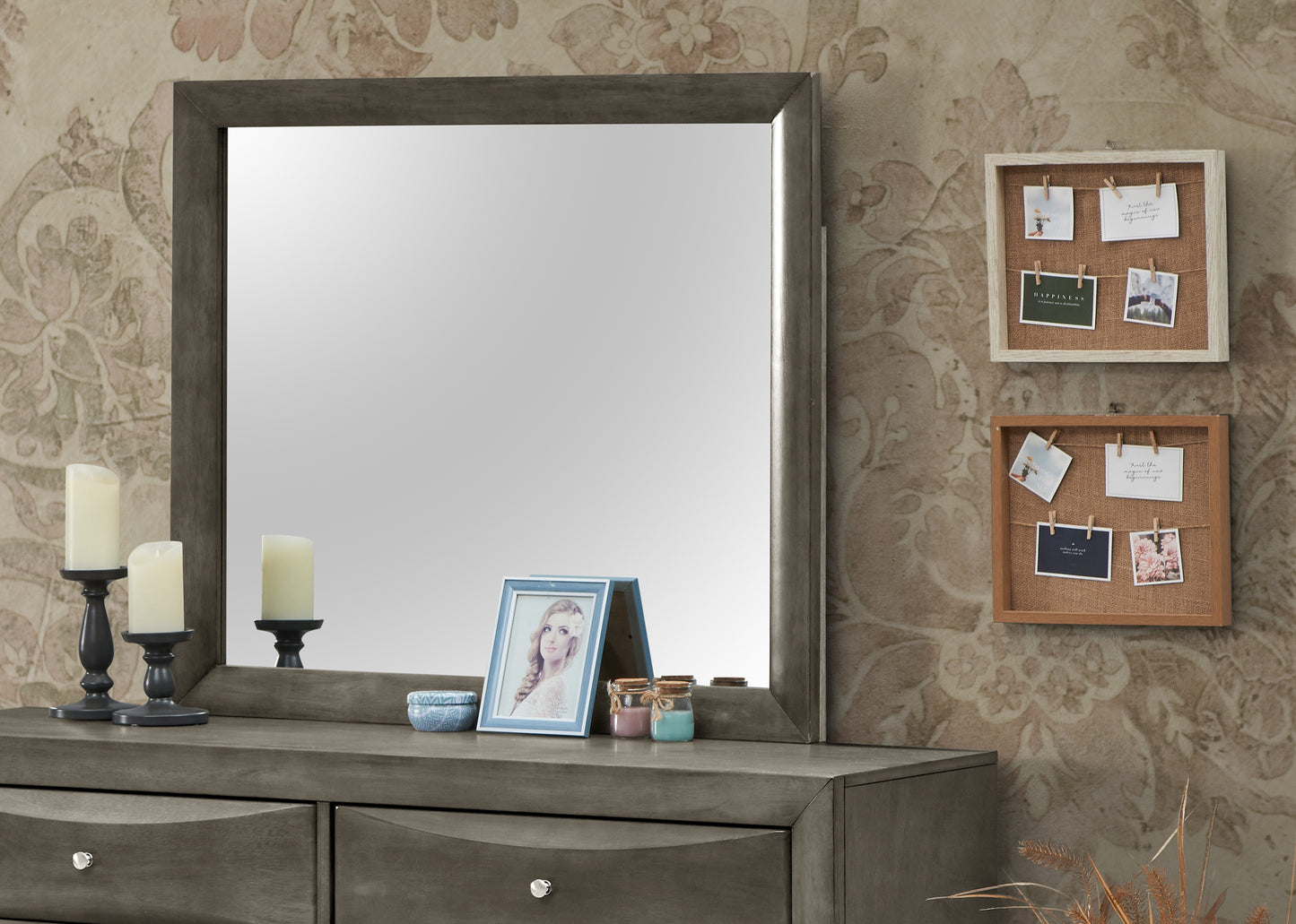 Gray wood dresser with large mirror and decorative frame