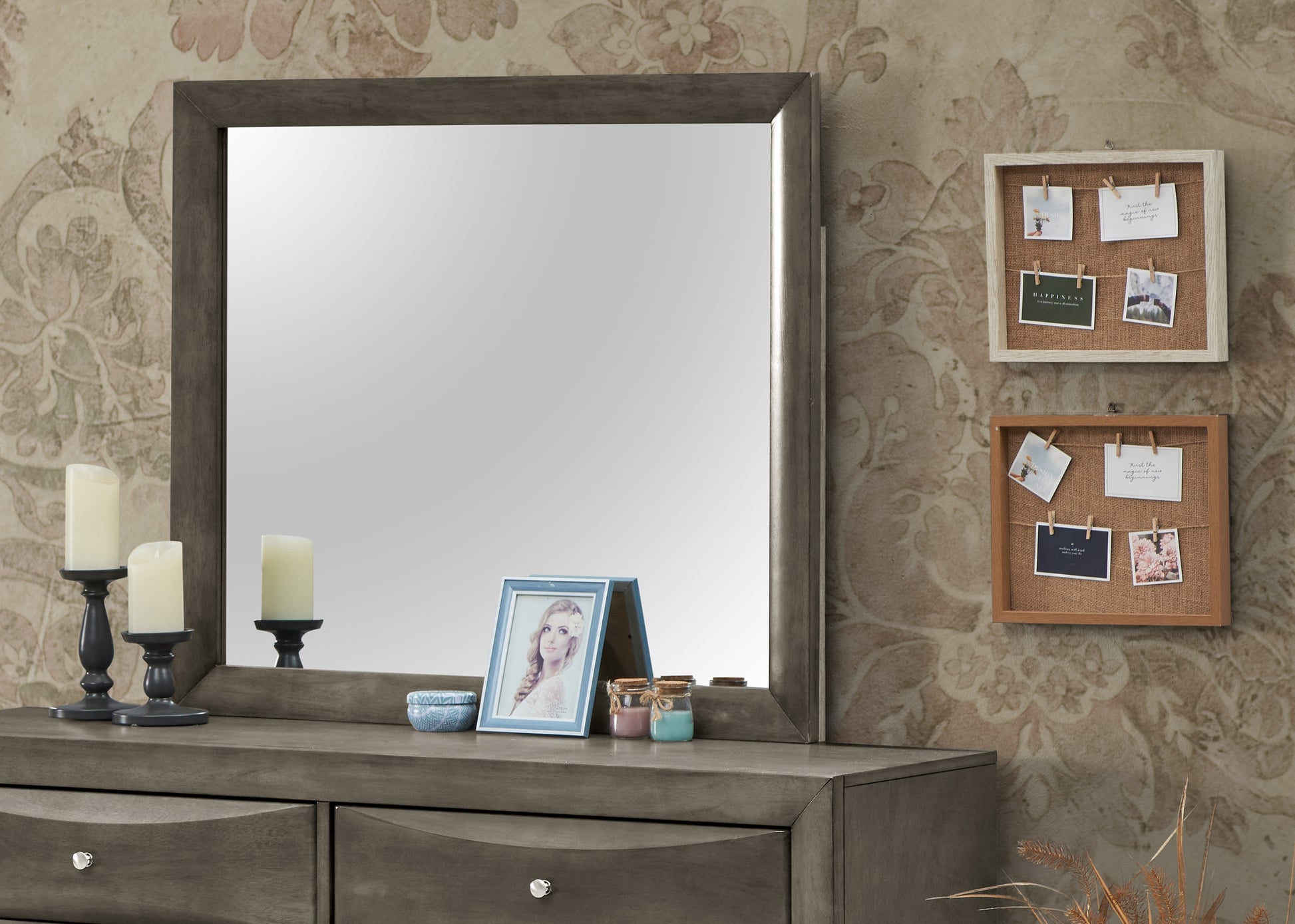 Gray wood dresser with large mirror and decorative frame