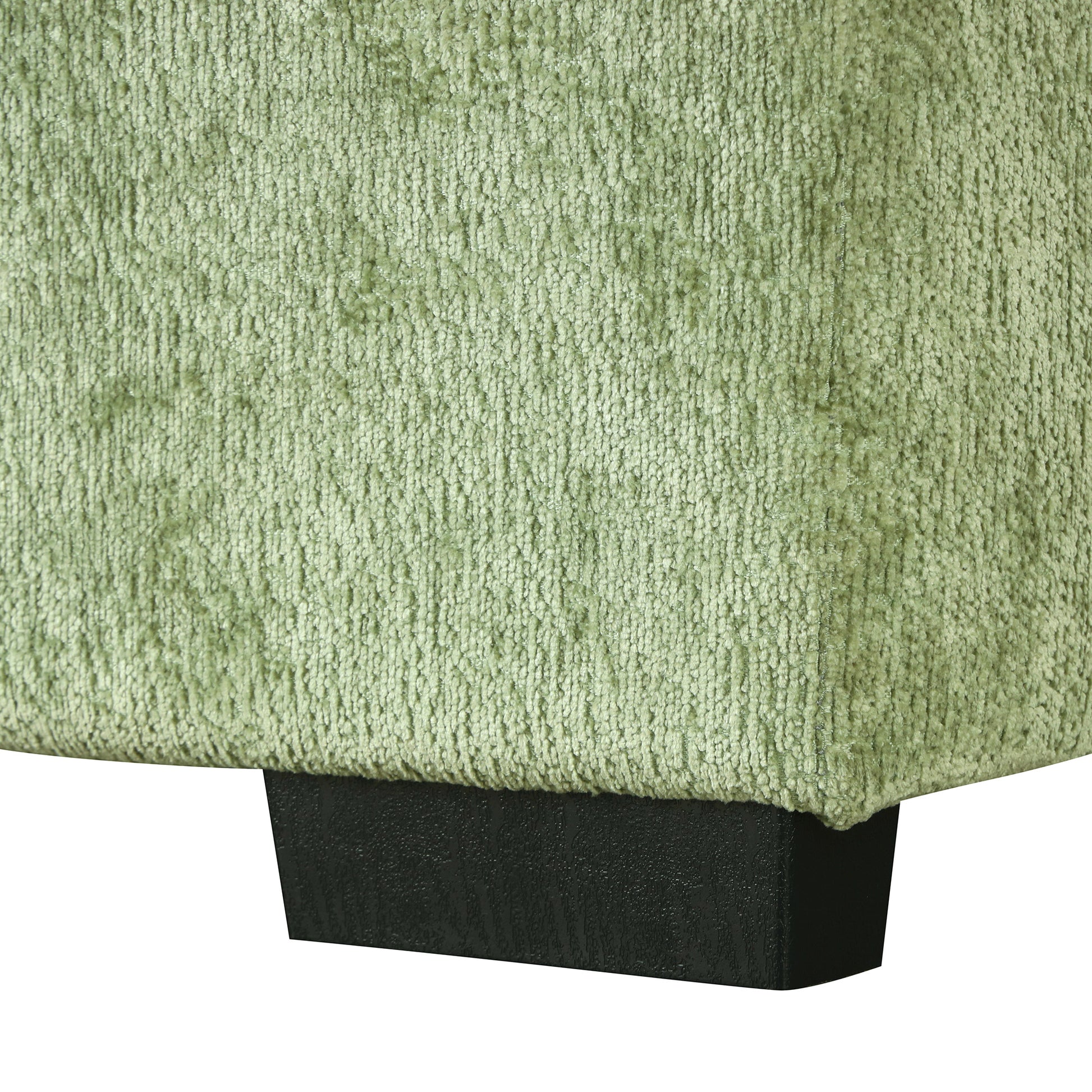 Light green chenille fabric swatch with visible texture and a dark wood block foot