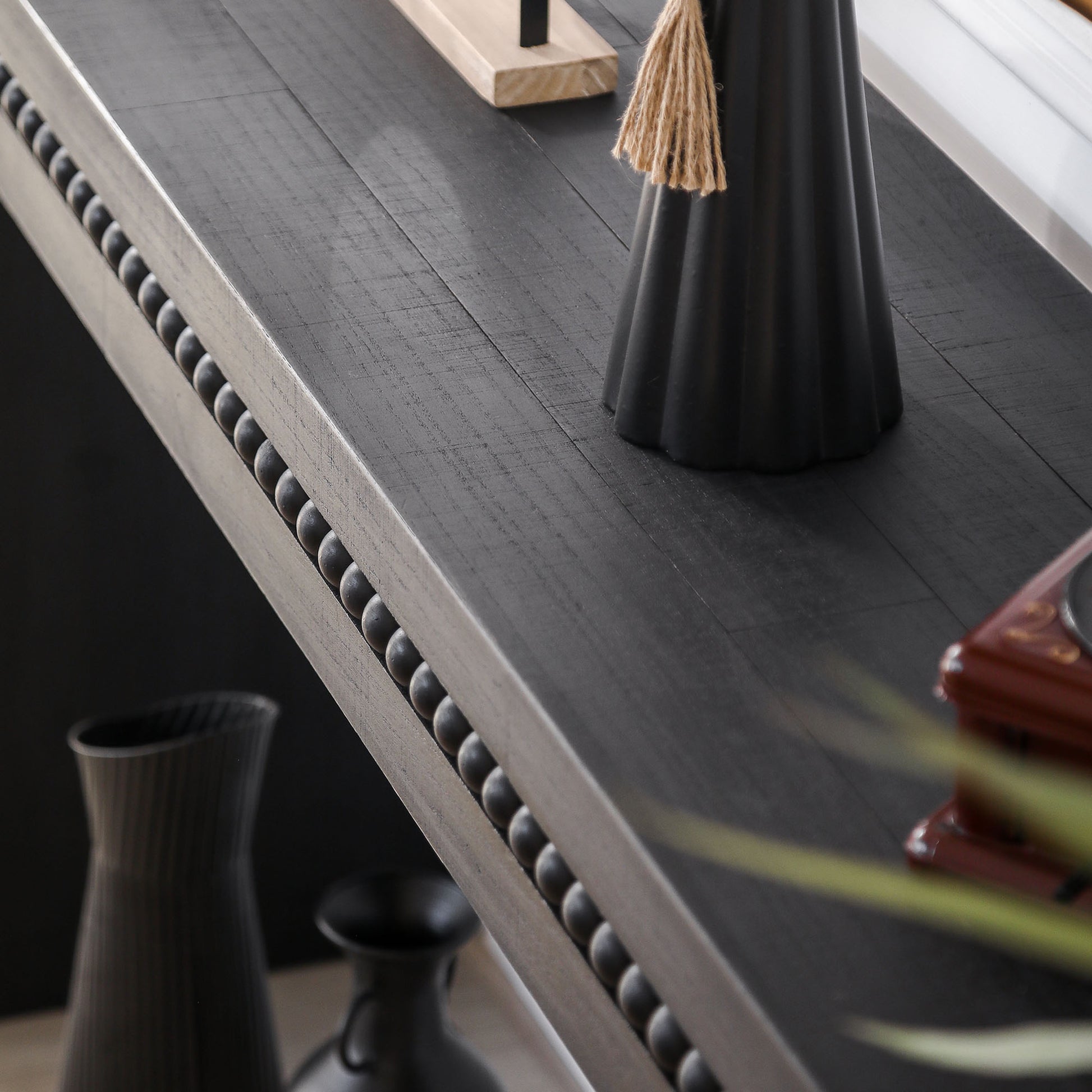 Dark grey distressed wood console table with beaded trim detail perfect for entryways