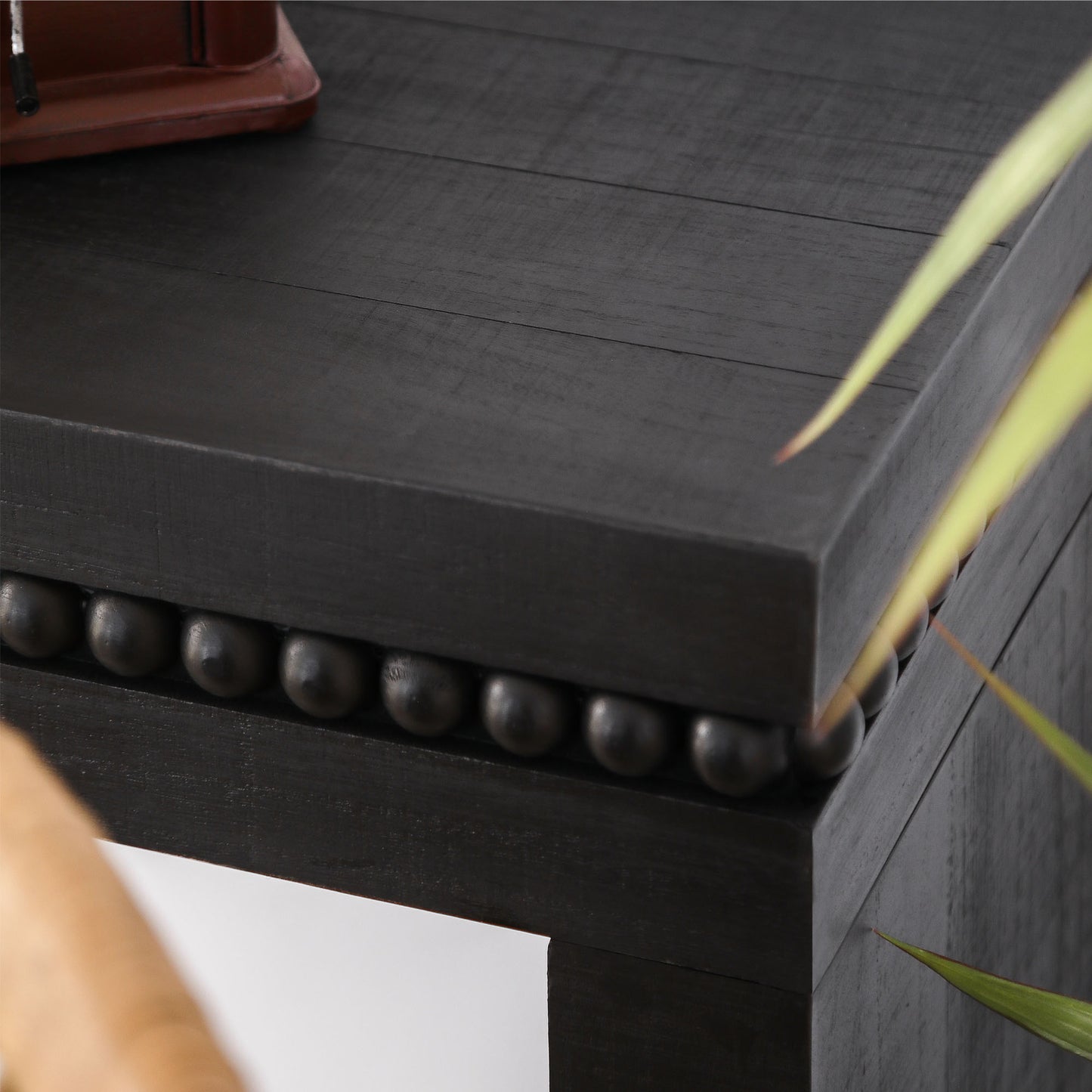 Dark wood textured table edge with decorative bead trim