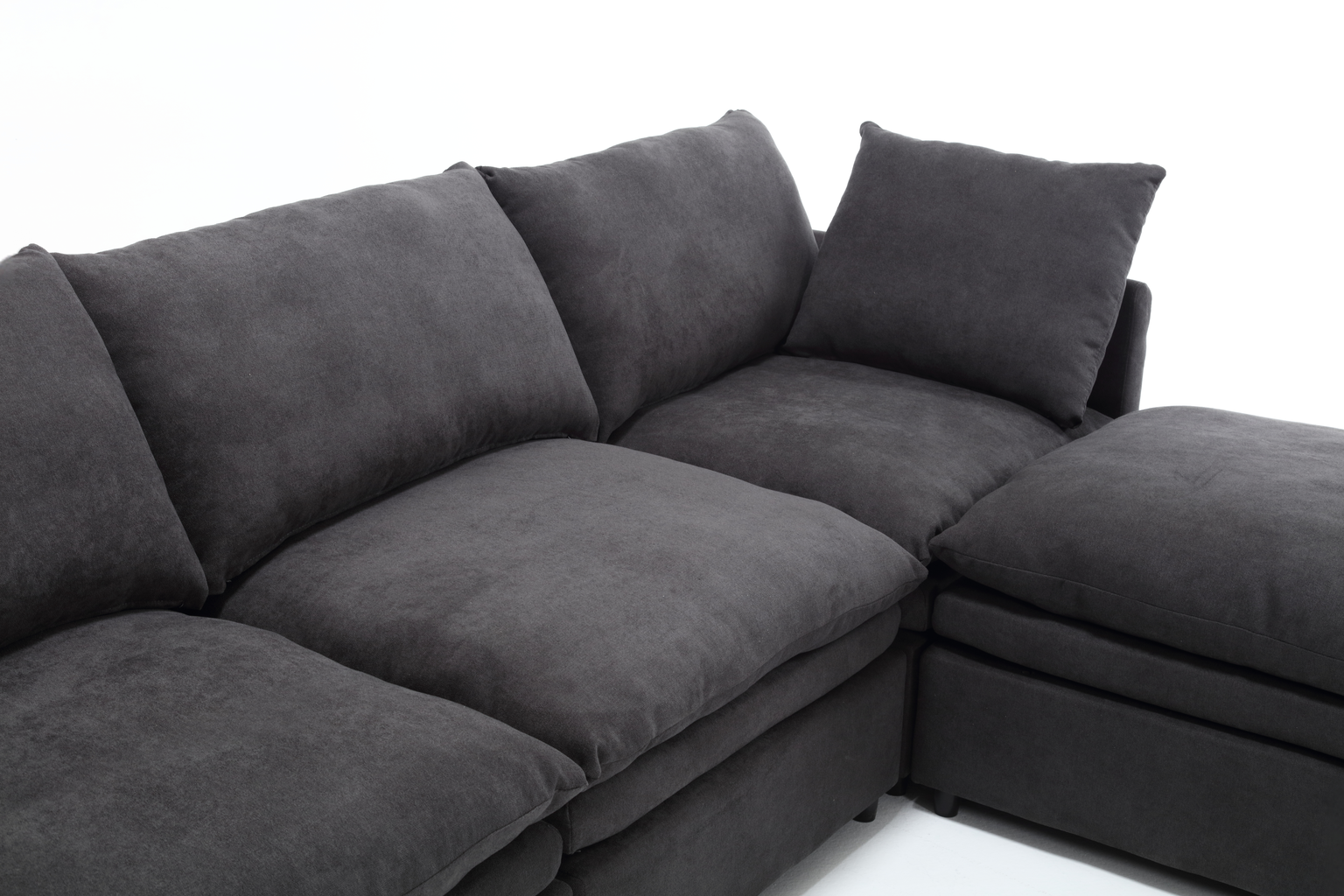 Dark gray modular sectional sofa with plush cushions and a chaise