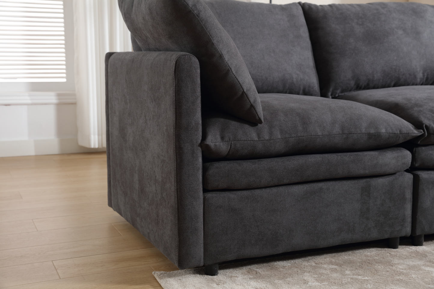 Plush charcoal grey sectional sofa with deep cushions and a modern design