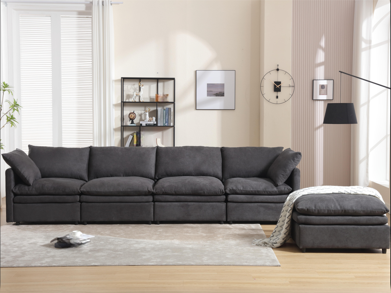 Deep charcoal modular sectional sofa with plush cushions and matching ottoman