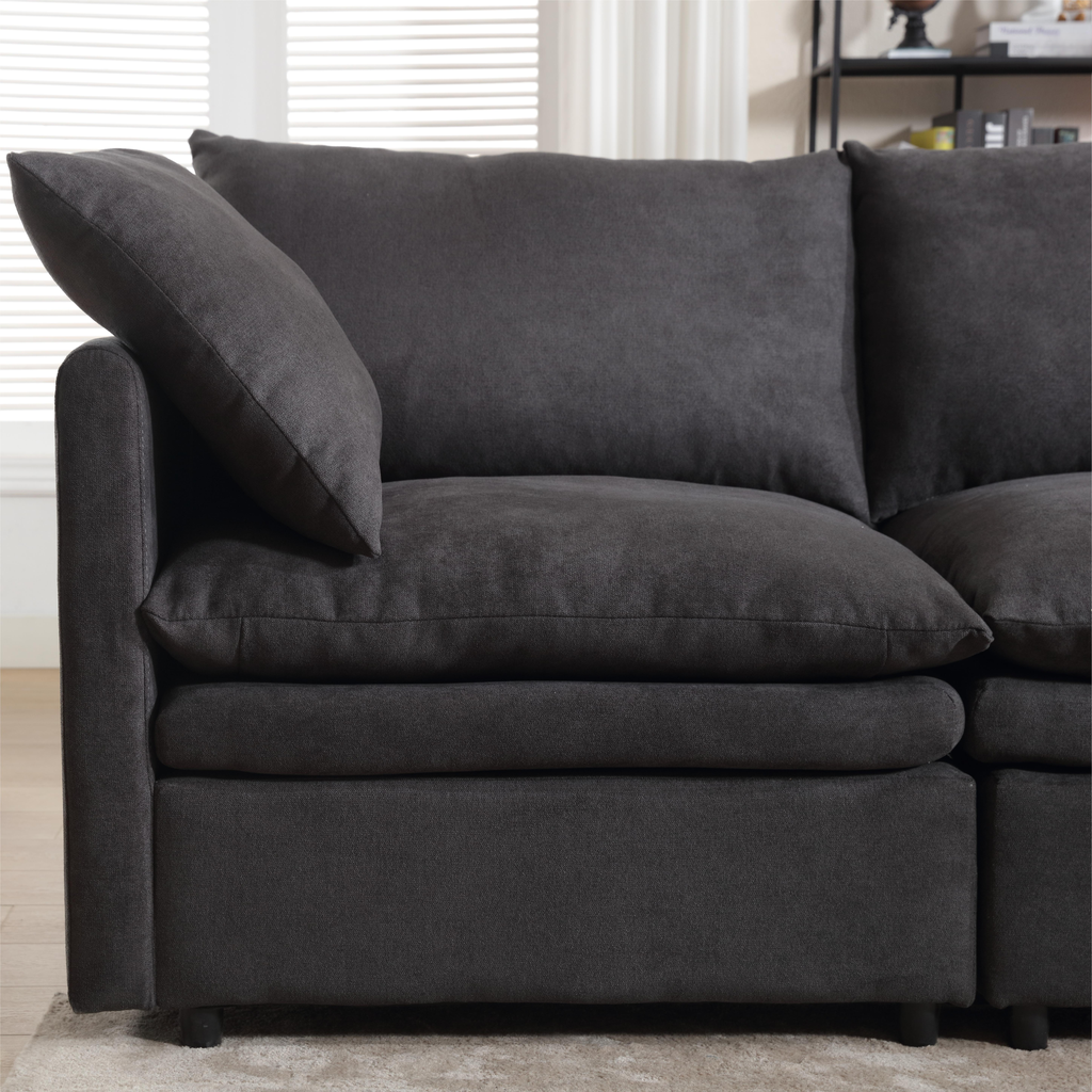Deep charcoal sectional sofa with plush cushions and a modern design