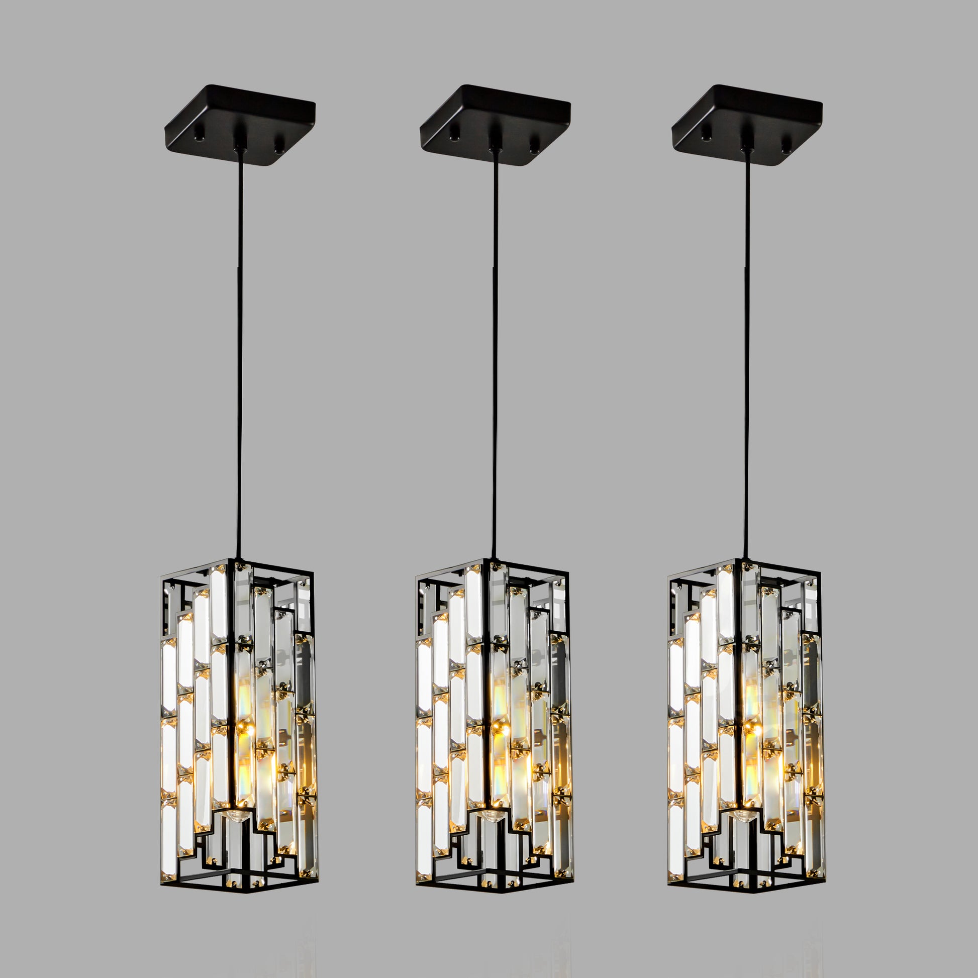 Three modern rectangular pendant lights with black frames and clear crystal accents