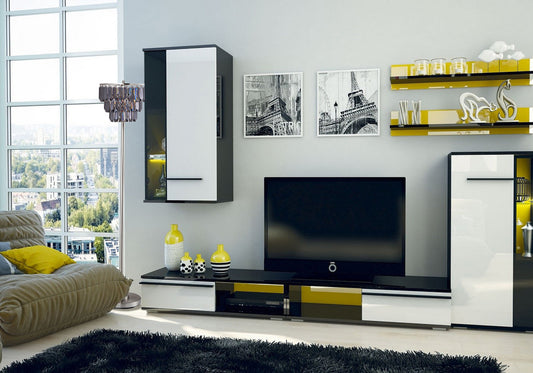 Modern black and white media console with yellow accents housing a TV