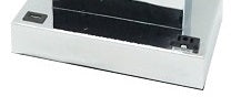 Silver metal base of an electronic device with black accents and a power button