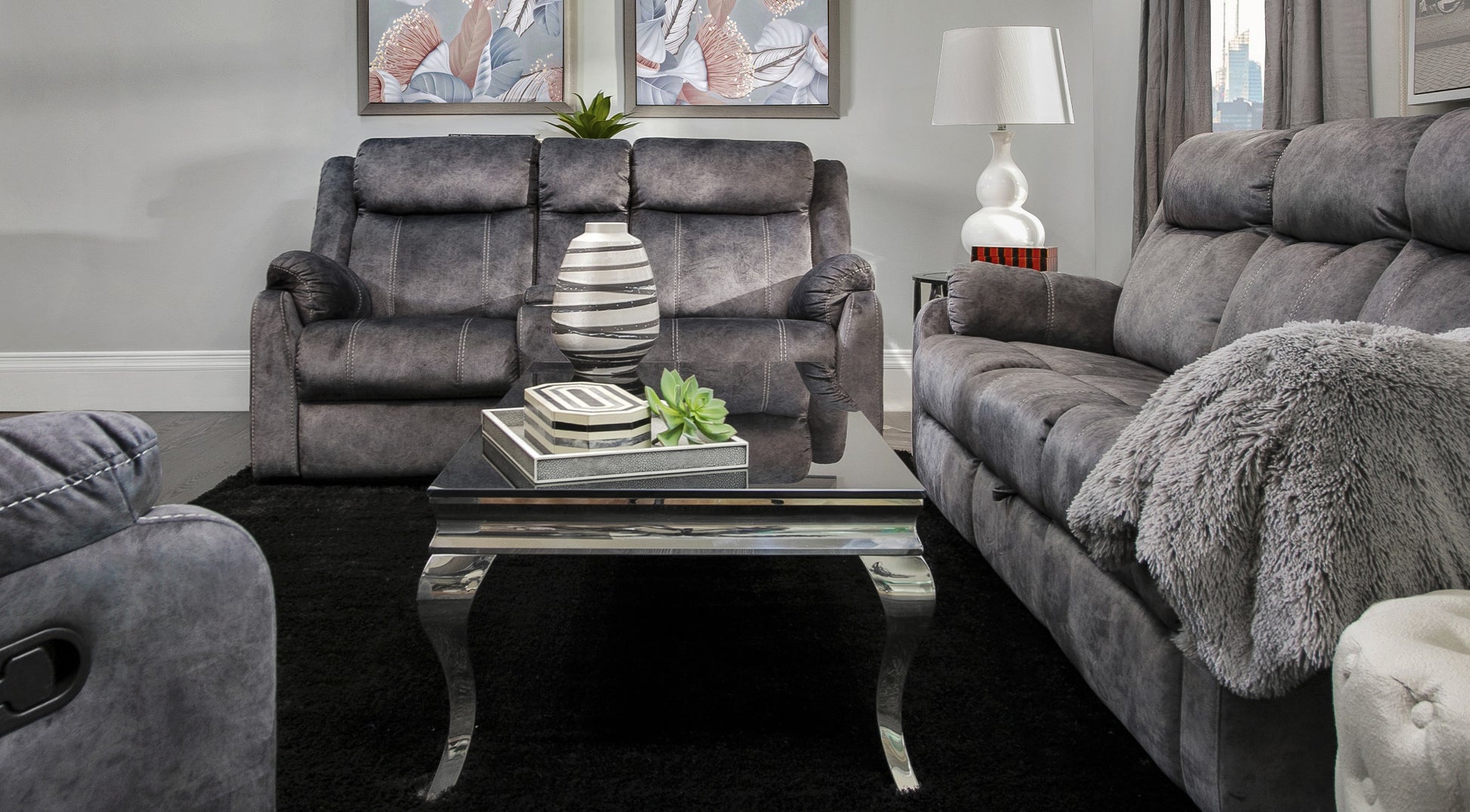 Charcoal grey reclining sofa set with plush fabric and decorative stitching